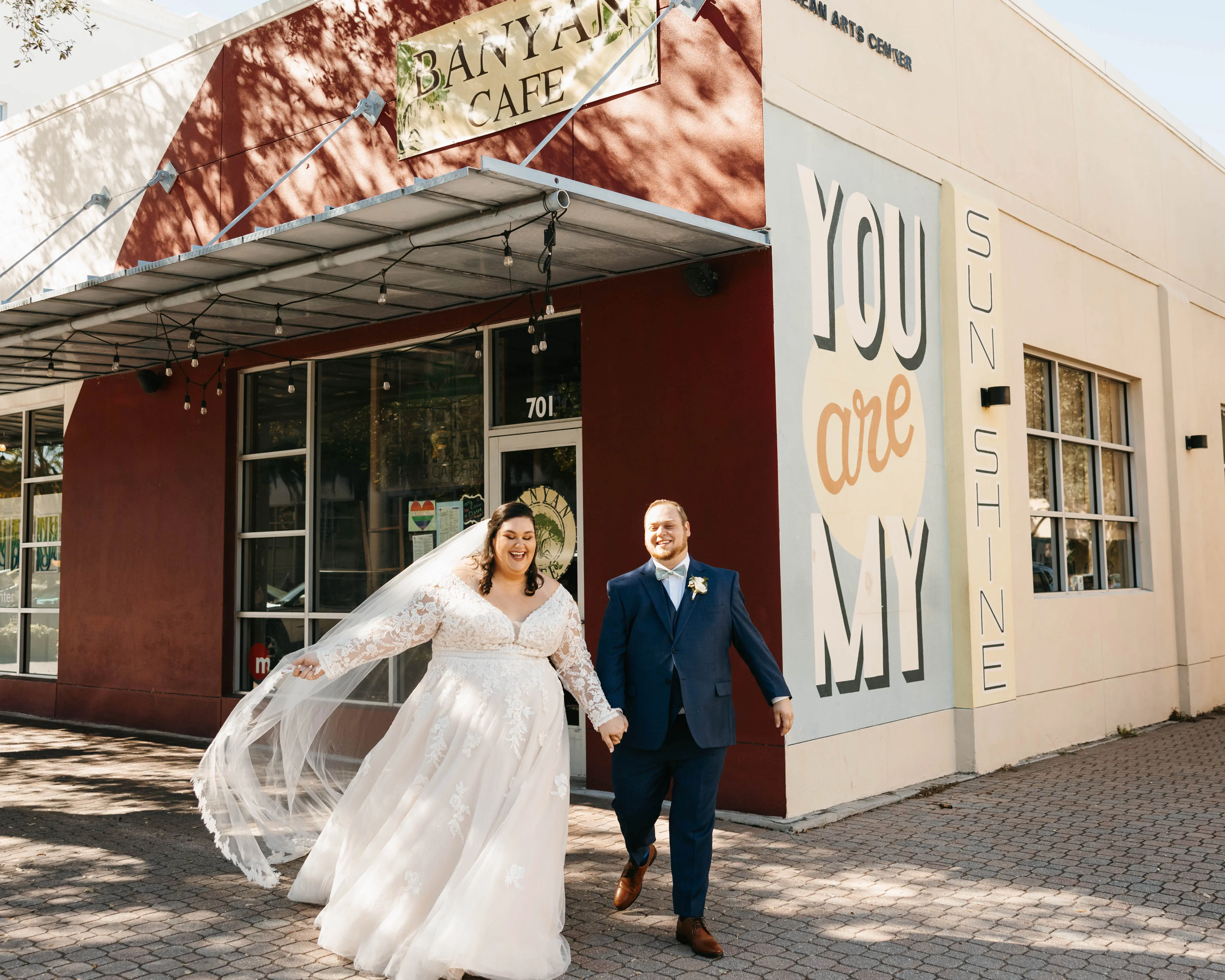 Groom With Bride Wearing Illusion Sleeve A-Line Wedding Dress Raphael By Maggie Sottero