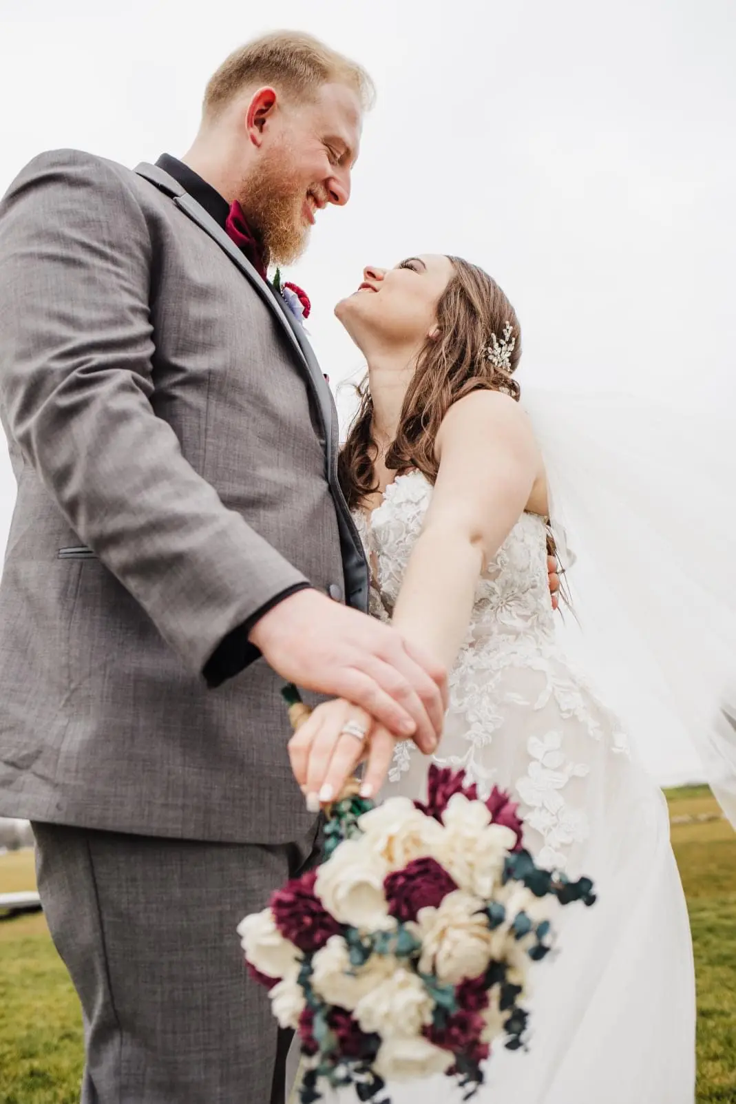Bride And Groom Standing Together. Bride Wearing Lace Tulle Wedding Dress Called Stevie By Maggie Sottero