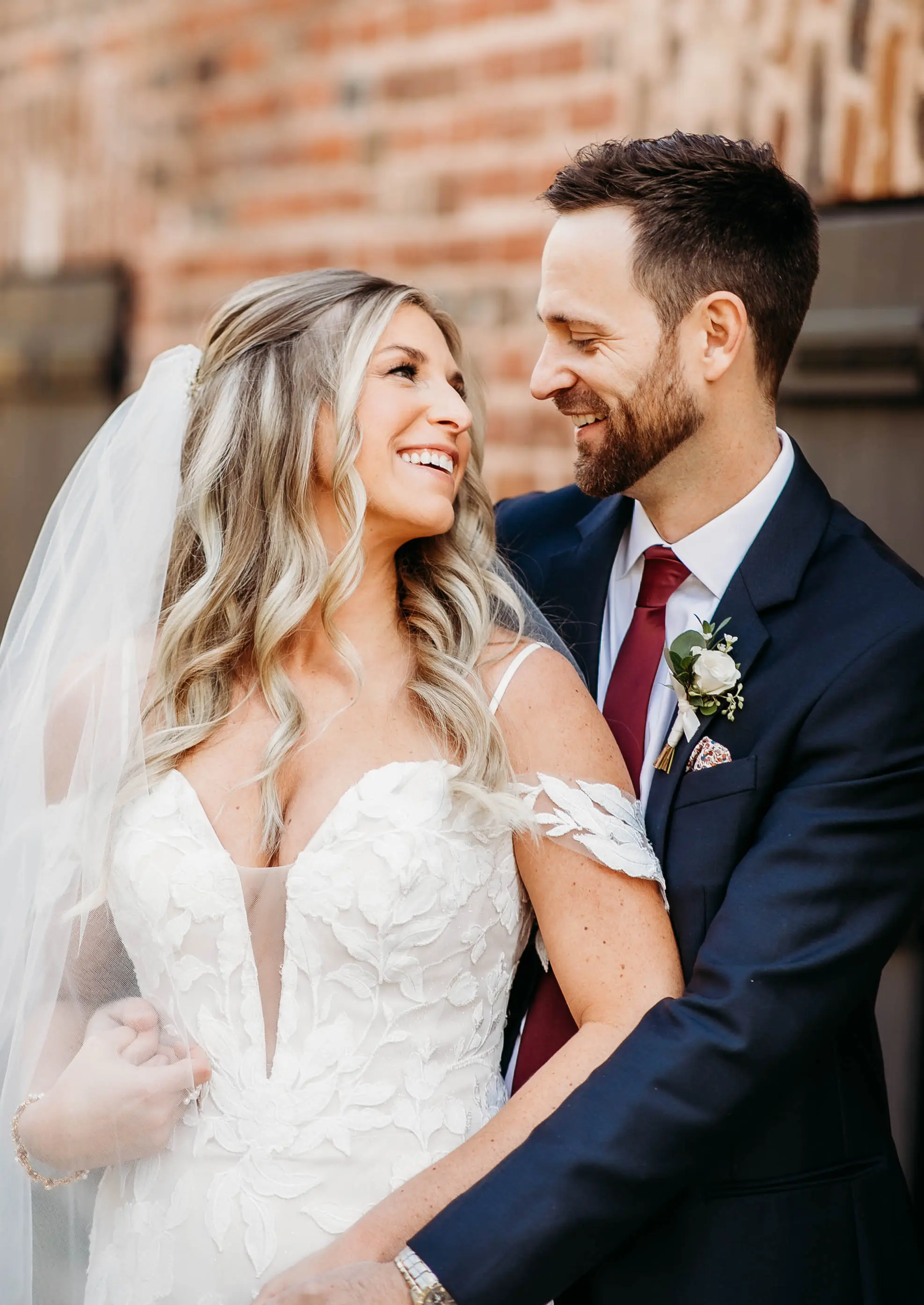 Bride Wearing Mermaid Wedding Dress With Oversized Lace Called Hattie By Rebecca Ingram With Groom