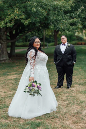 Bride Wearing Vintage Royalty Long Sleeve Wedding Dress Called Raphael By Maggie Sottero While Groom Looks On