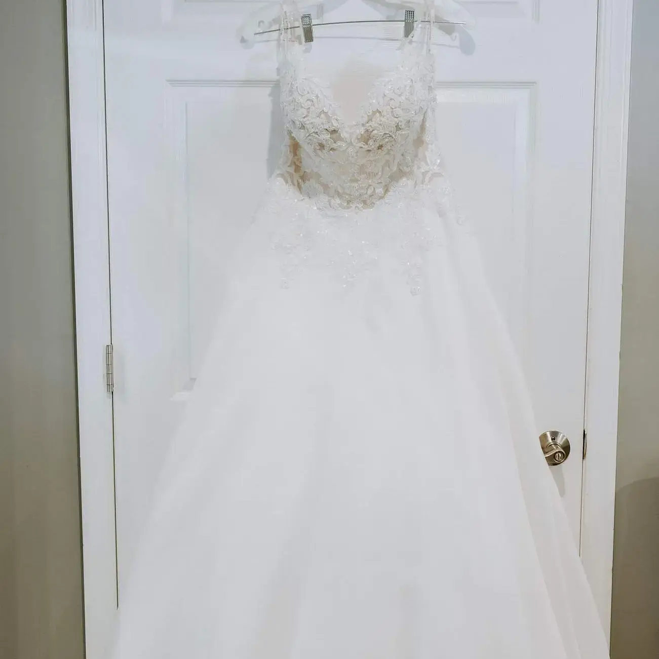 Lace Aline Wedding Dress called Savannah by Maggie Sottero Hanging on a Doorframe