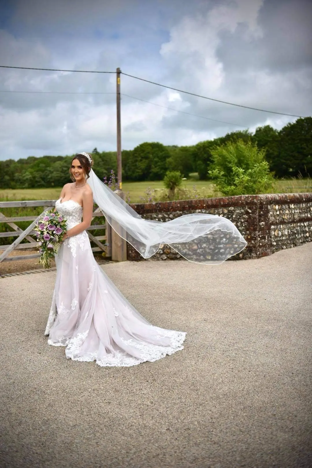 bride with groom in lacy mermaid wedding dress