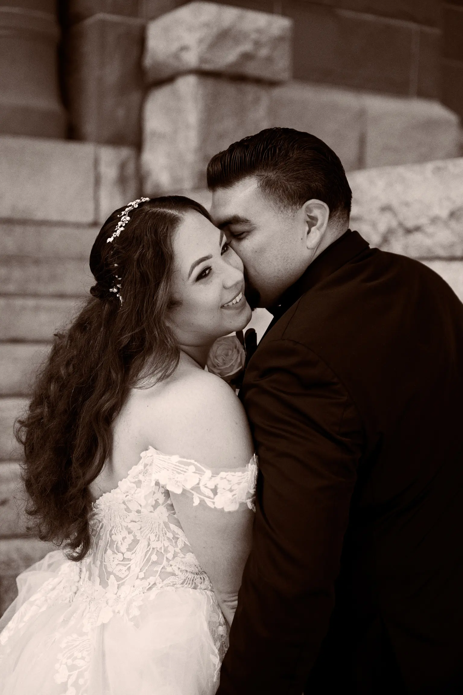 Groom Kissing Bride Wearing Lace Ballgown Wedding Dress Called Harlem By Maggie Sottero