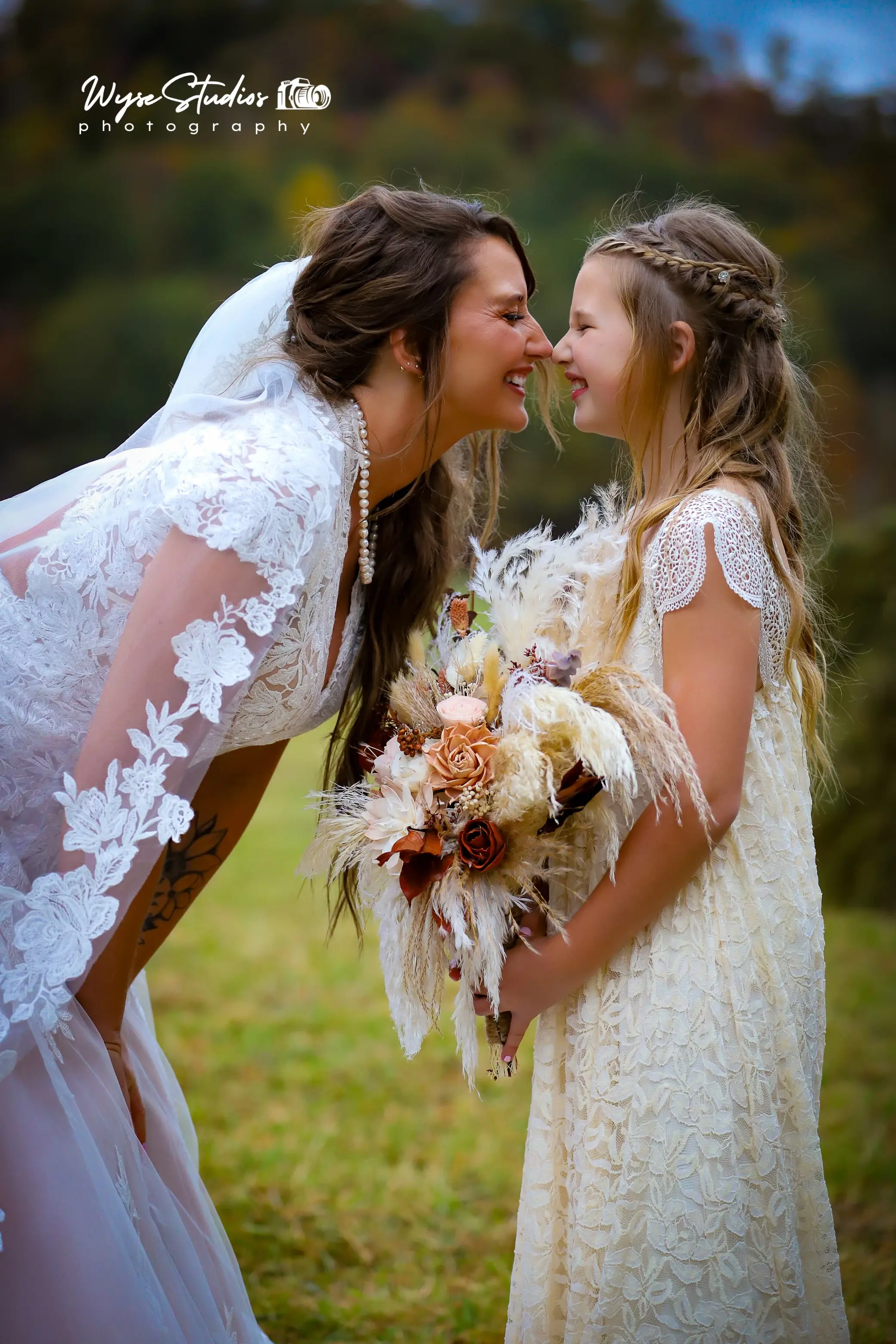 Bride wearing Kingsley wedding gown by Sottero and Midgley with a little girl