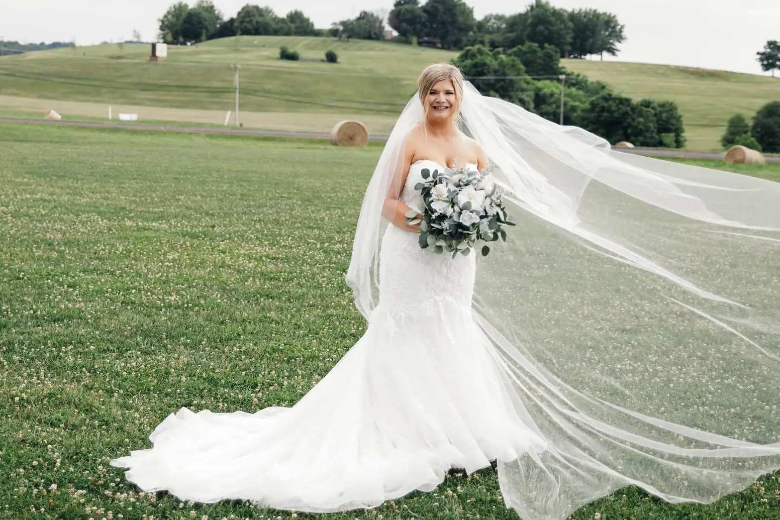 Bride wearing glamorous plus size mermaid wedding dress