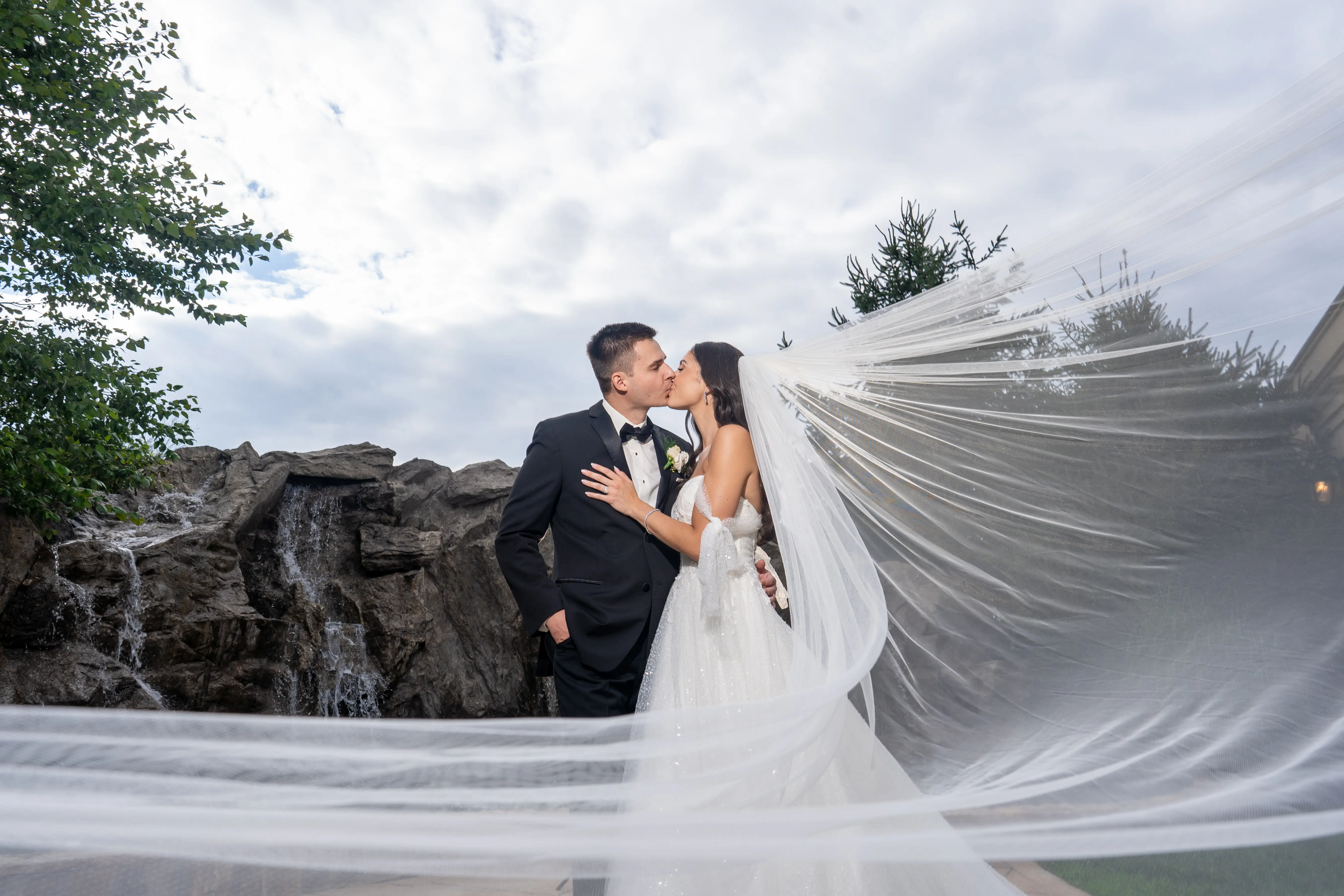 Bride Wearing Sparkly Ballgown Wedding Dress Called Shasta By Sottero And Midgley Kissing Groom