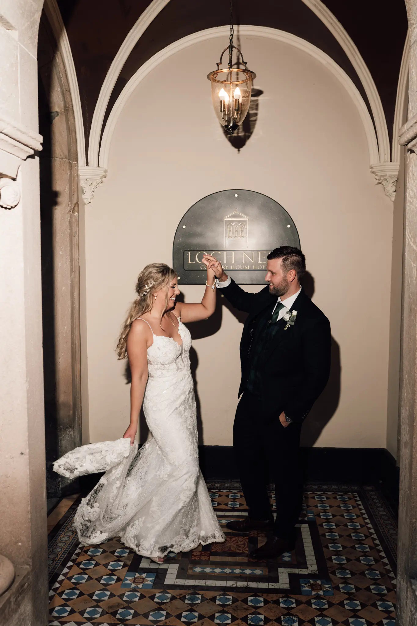 Groom with Bride in Romantic Lace Sheath Wedding Gown with Shimmering Lace Motifs Called Tuscany Lynette by Maggie Sottero