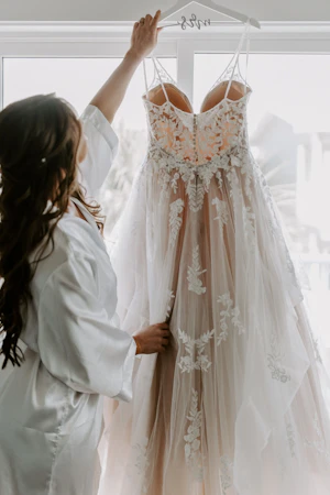 Real Bride wearing A-Line wedding dress with tiered ruffled called Lettie by Rebecca Ingram.