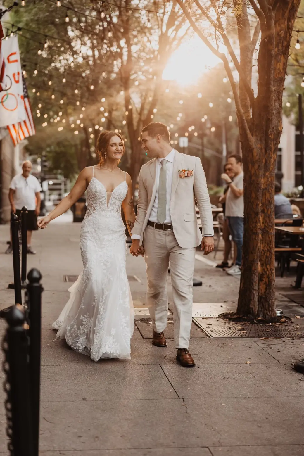 Bride wearing Sydney by Maggie Sottero walking with her husband