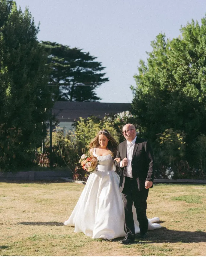 Bride in Mikado Scoop Neckline Ball Down Wedding Dress Selena by Maggie Sottero with Man Walking her Down Isle
