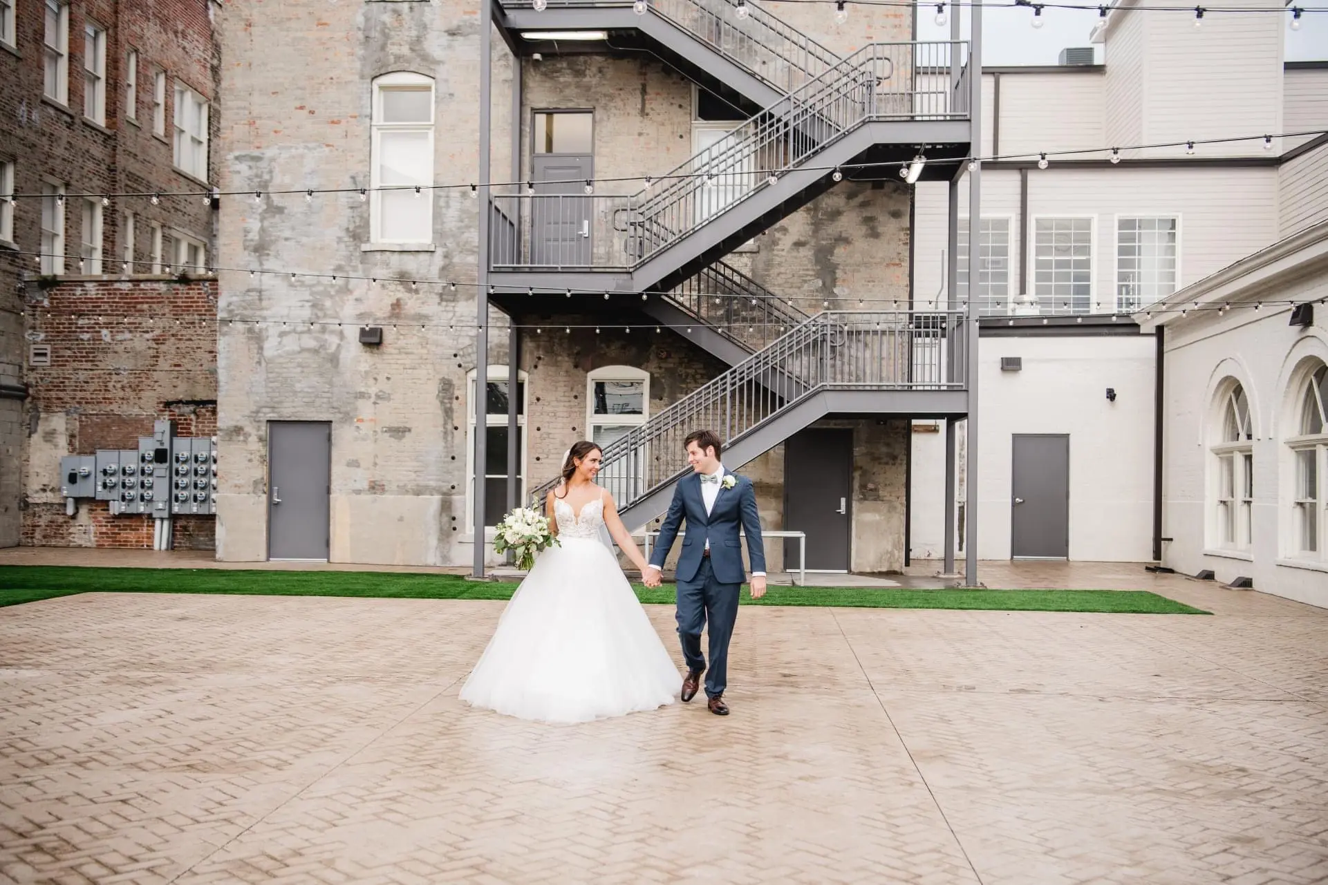 Bride wearing a boho princess wedding dress in lace and tulle