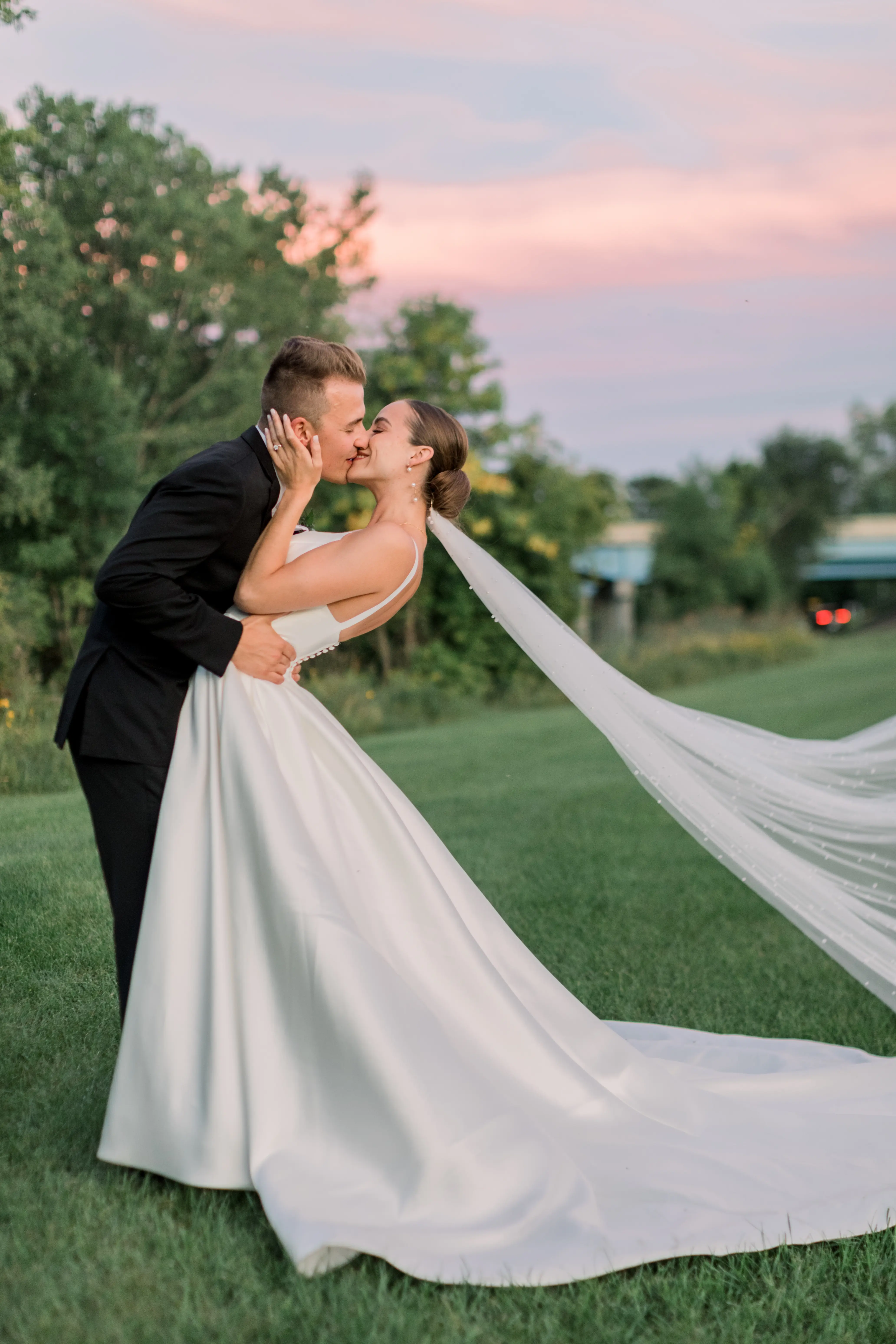 Bride Wearing Classic A-Line Wedding Dress Called Selena By Maggie Sottero Kissing Groom