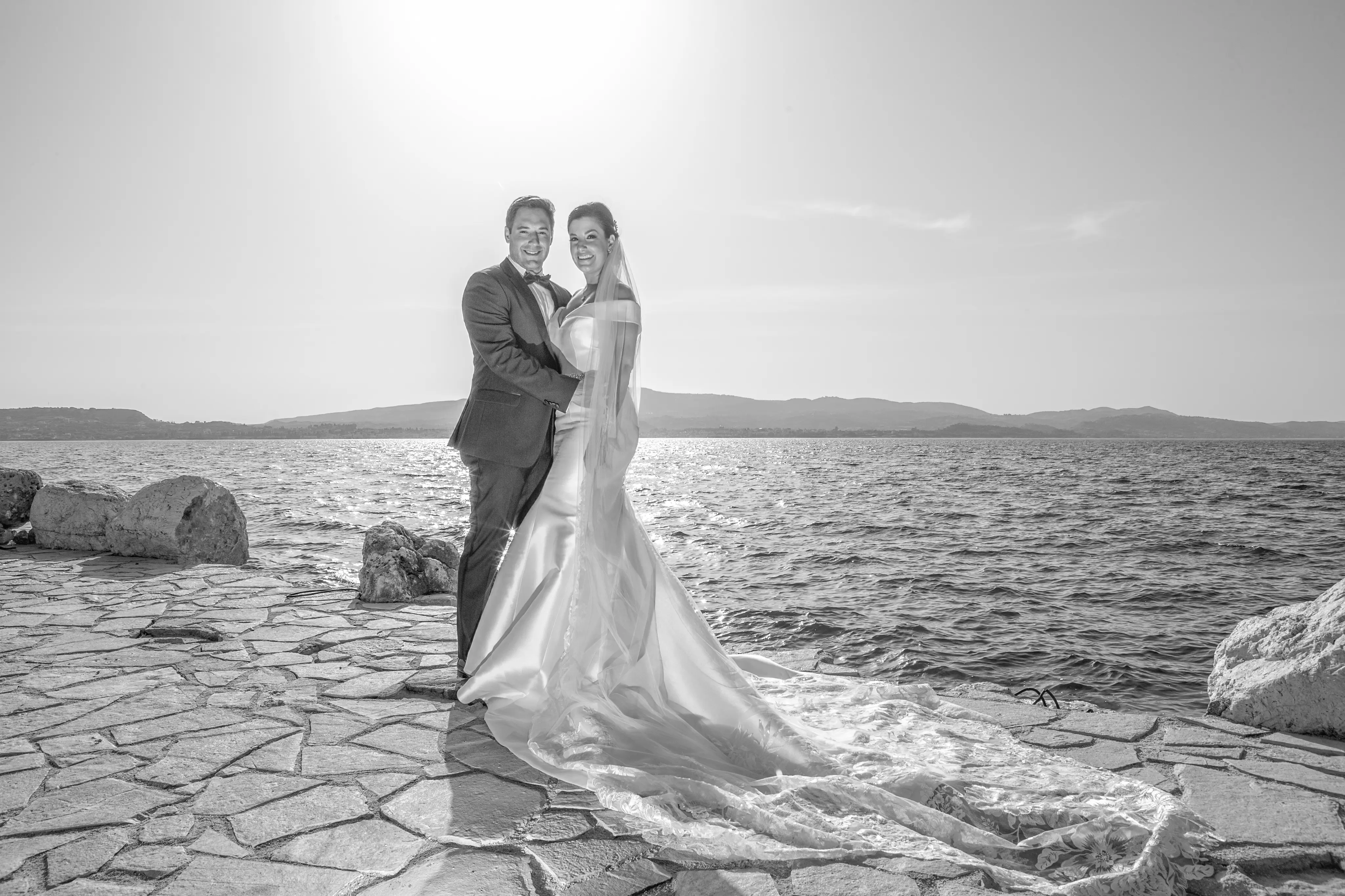 Bride wearing Simple Fit-and-Flare Wedding Dress called Josie by Rebecca Ingram on the beach with the groom