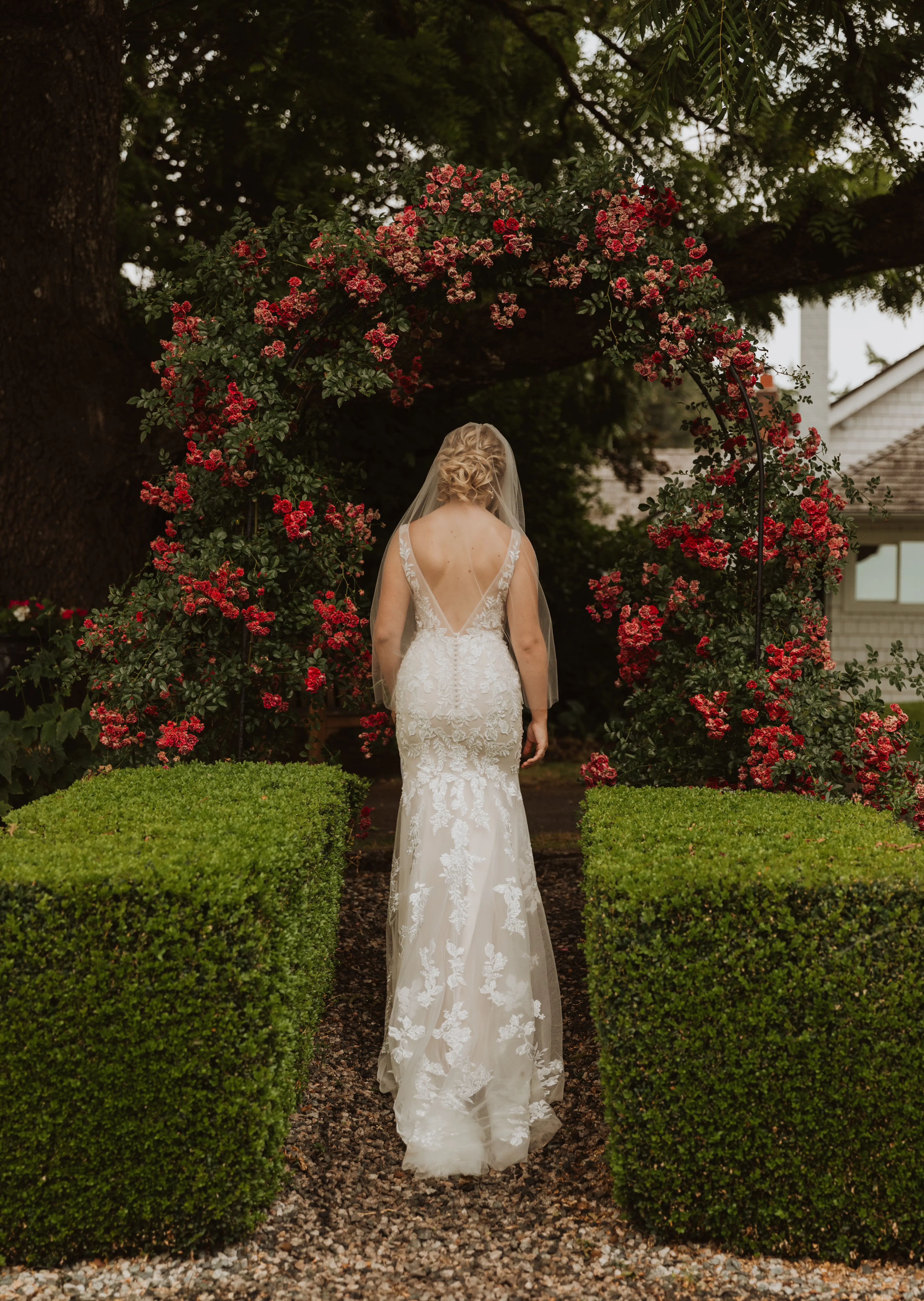 Bride wearing Greenley wedding dress by Maggie Sottero walking through a garden