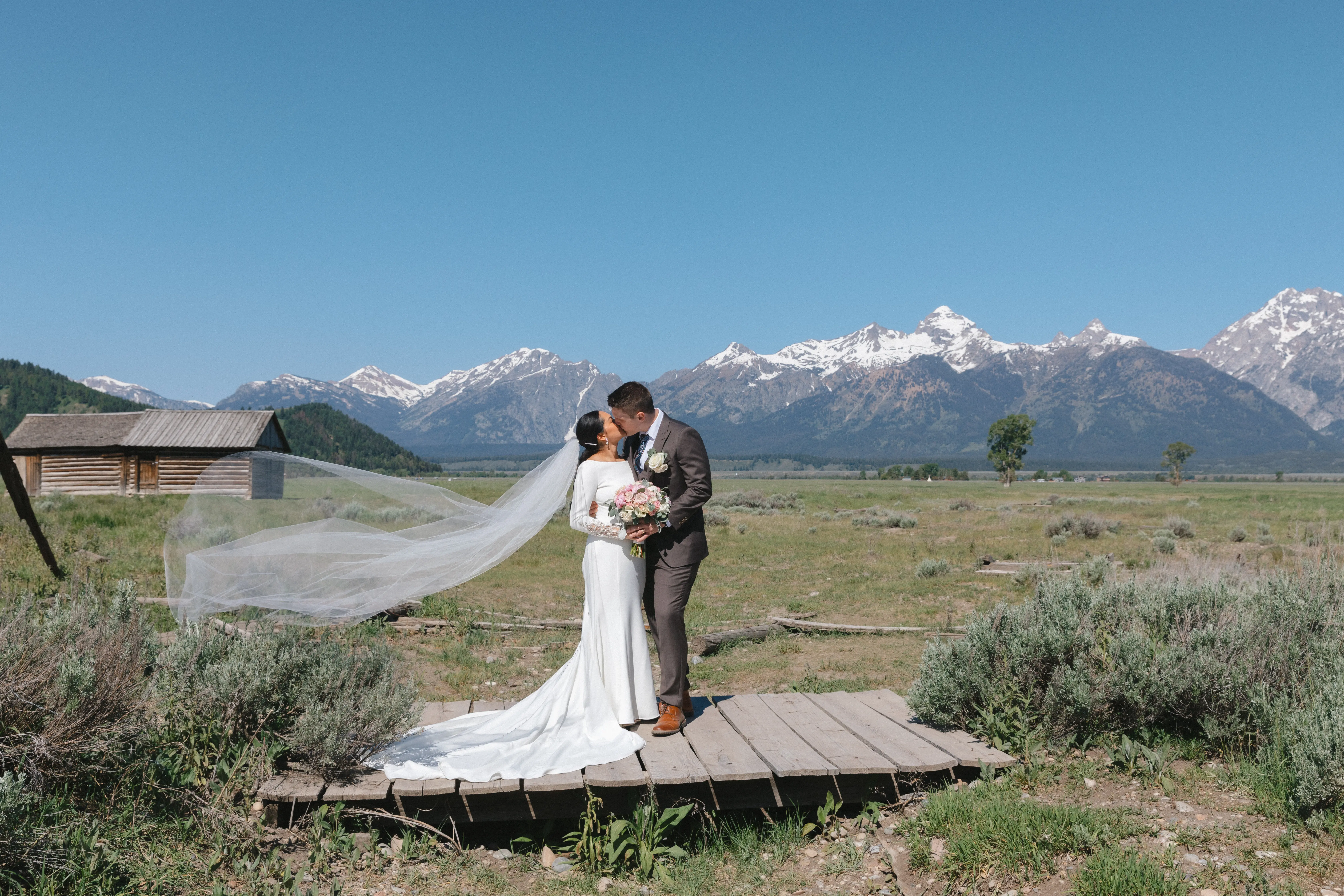 Bride wearing Aston by Sottero and Midgley kissing her husband