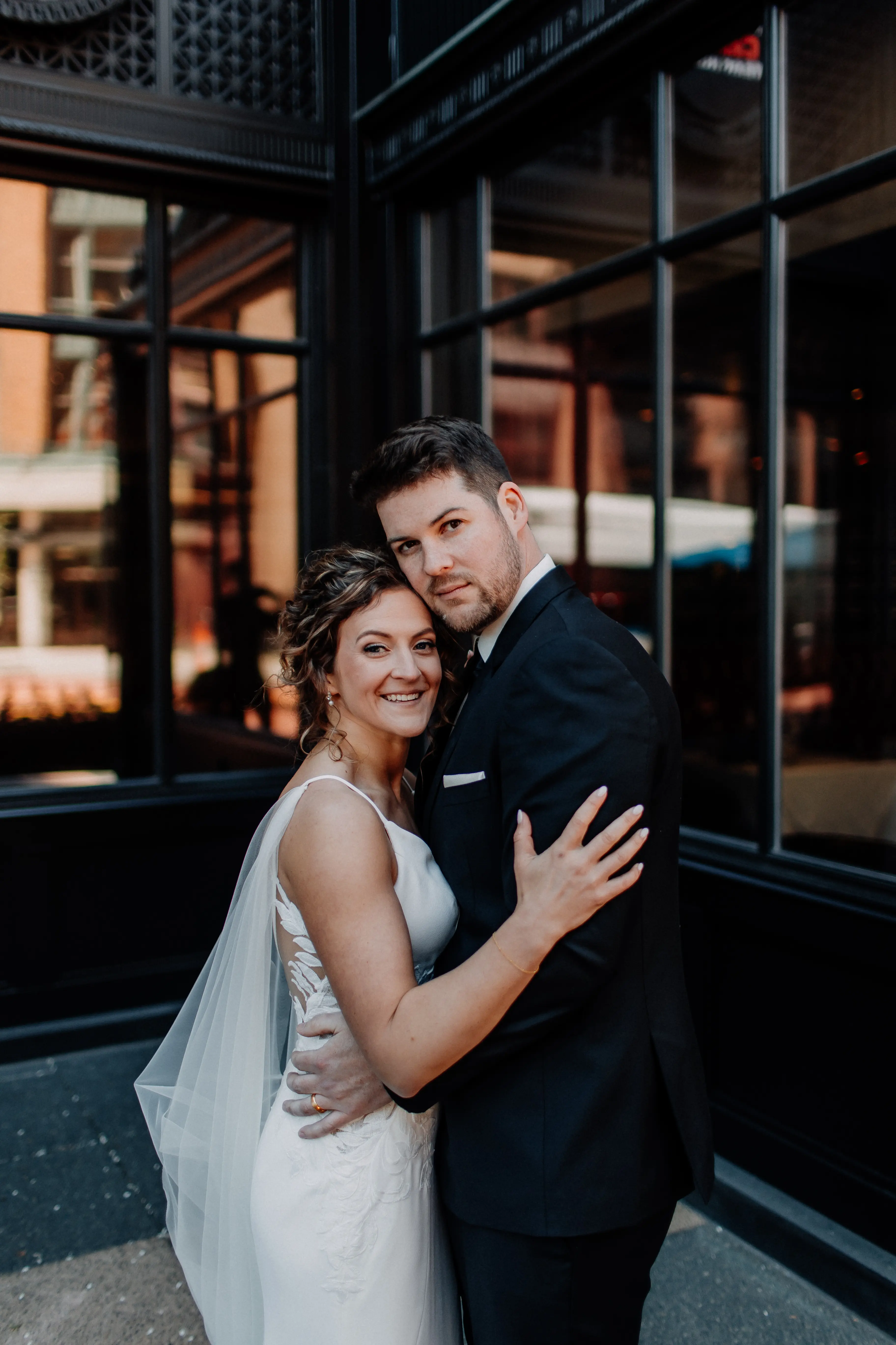 Bride wearing Dionne by Rebecca Ingram hugging her husband