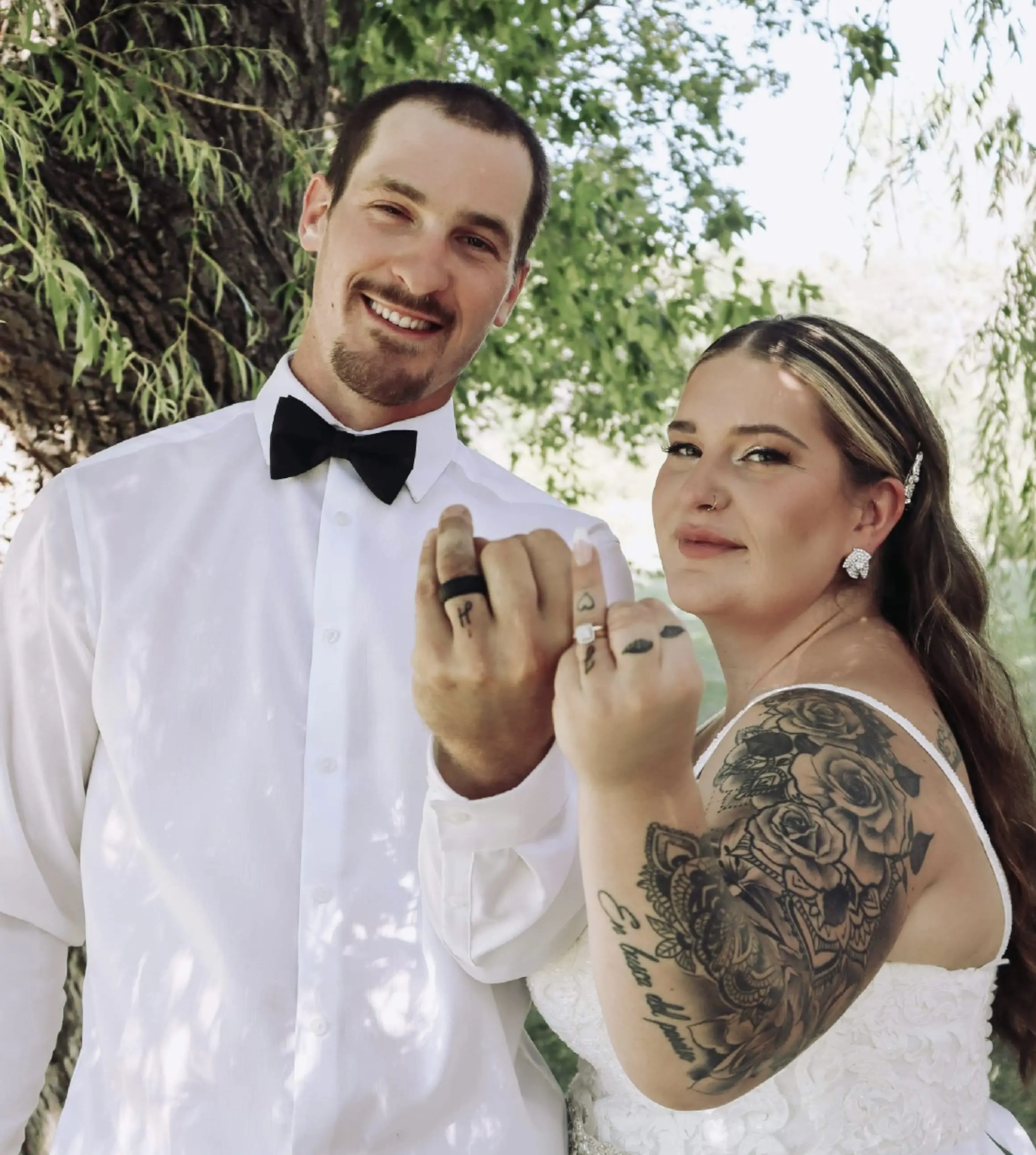 Bride Wearing Sheath Lace Wedding Dress With Beaded Belt Called Tuscany Lynette By Maggie Sottero And Groom Show Wedding Rings