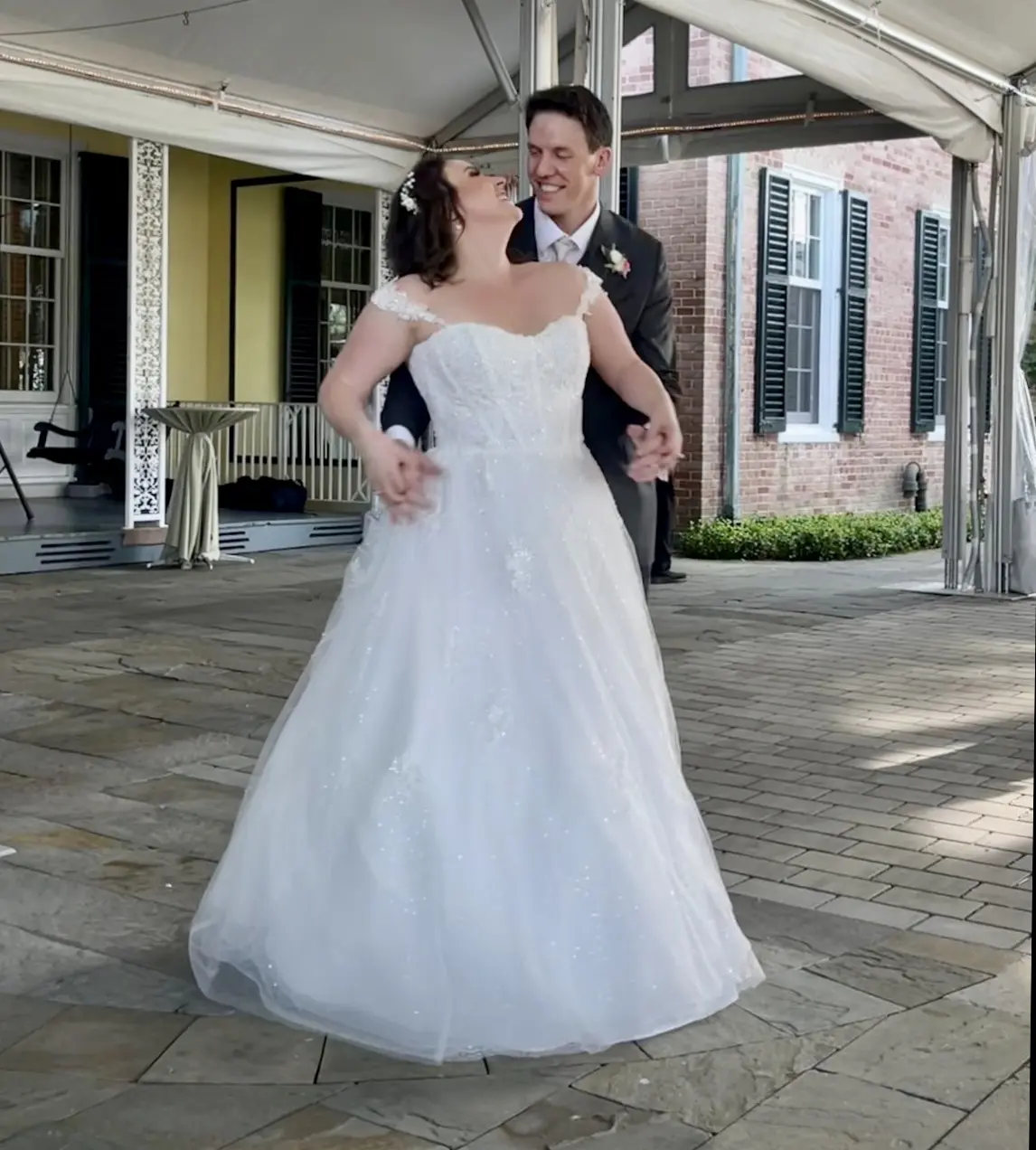 Bride wearing Mason by Sottero and Midgley smiling at her husband