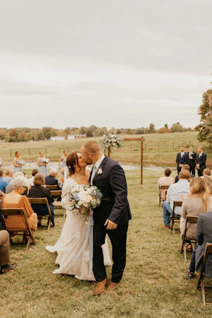 Bride wearing Lace A-line Wedding Dress called Tuscany Lane by Maggie Sottero kissing the groom