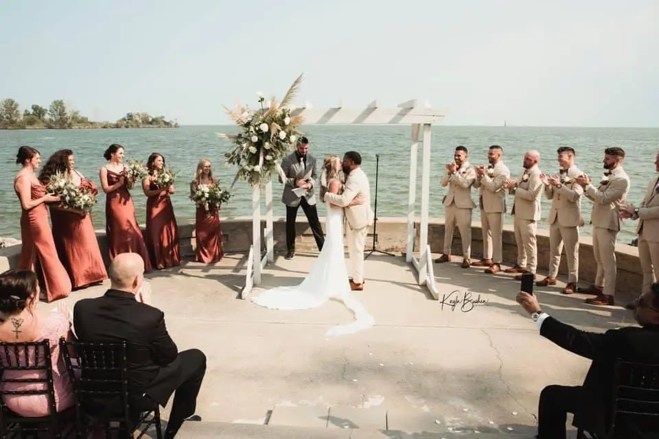 Bride with groom wearing sexy v back sheath wedding dress