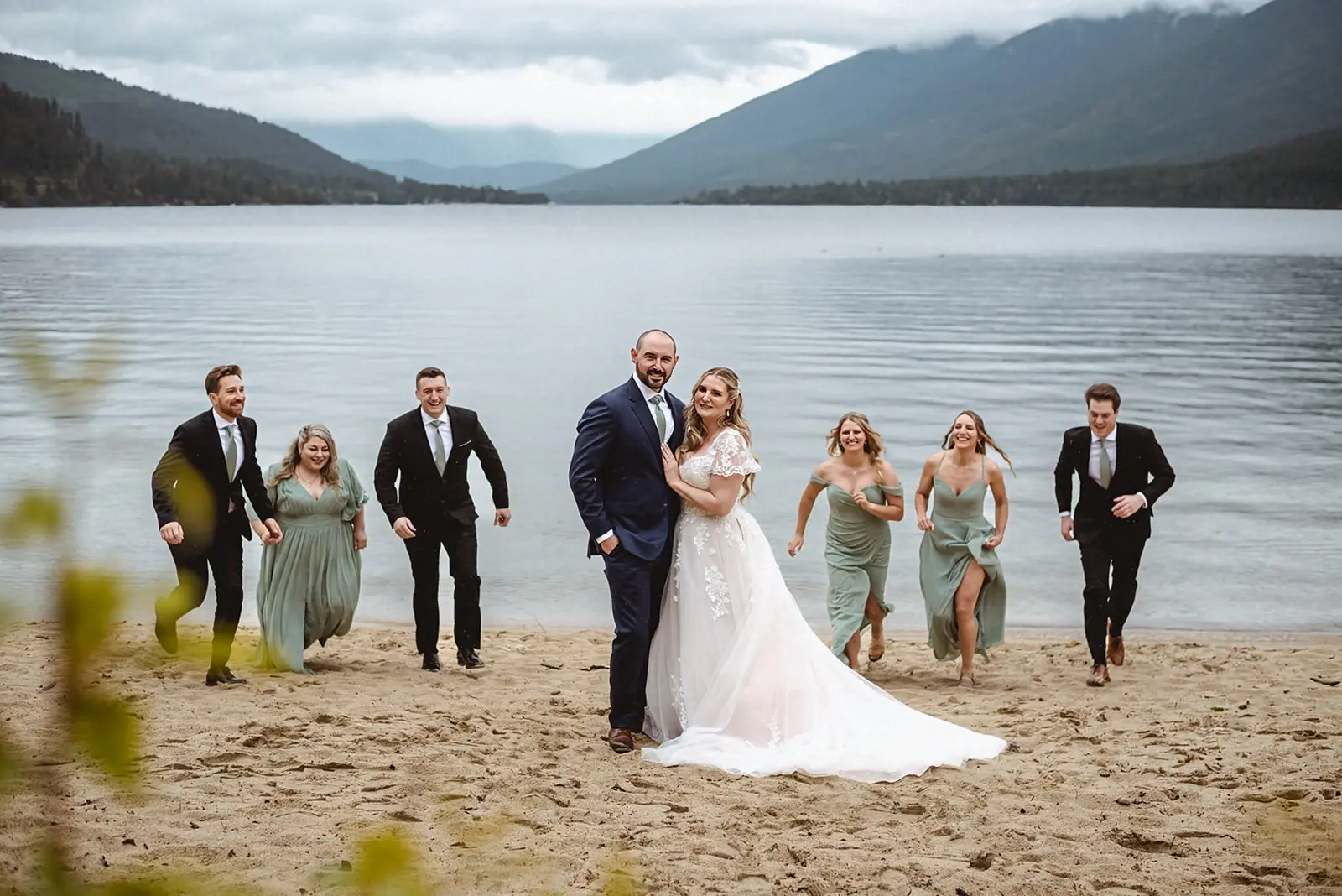 Bride Wearing Lace Aline Wedding Dress Called Harlem By Maggie Sottero With Wedding Party Running Behind Them