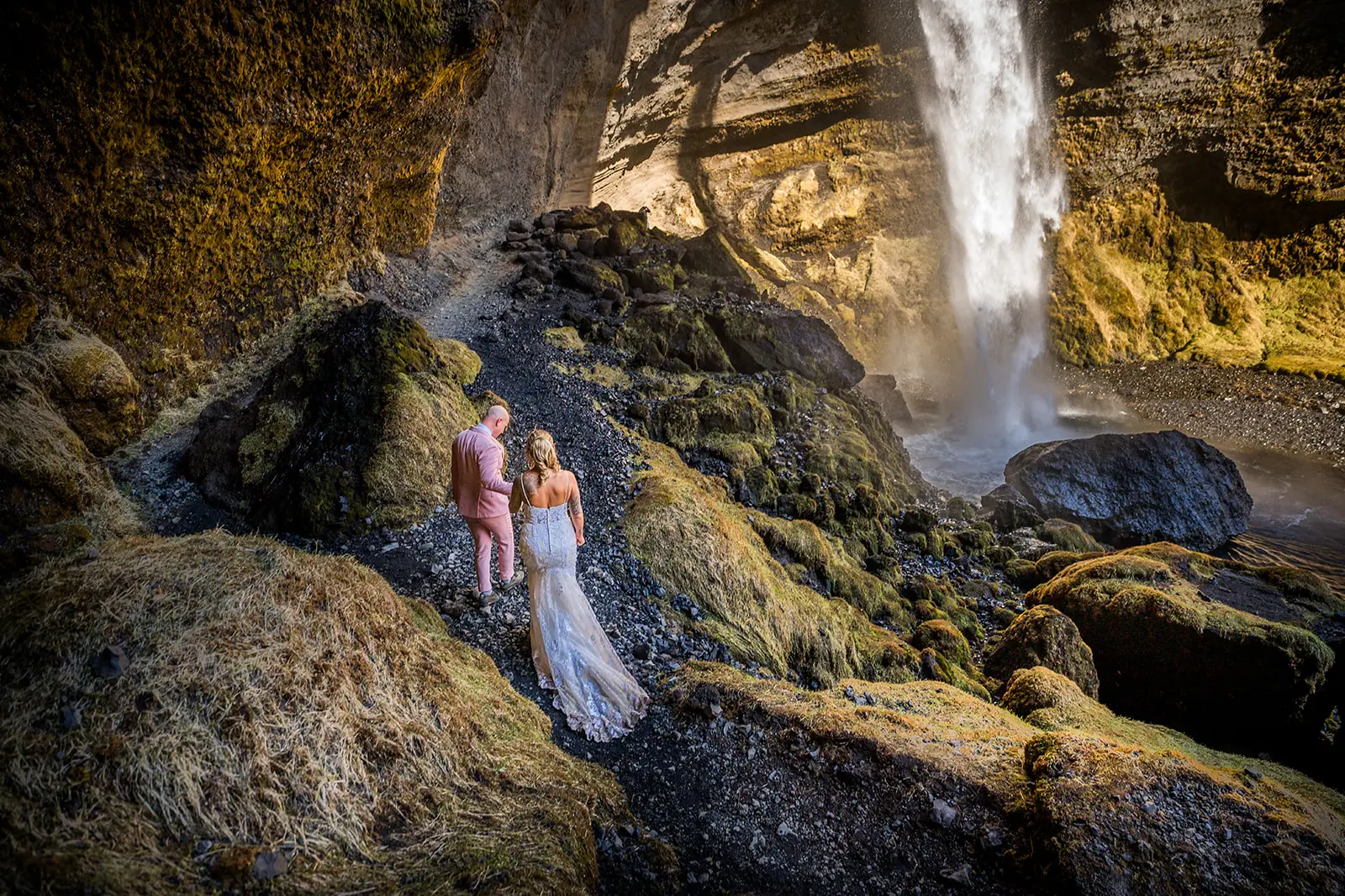 Bride wearing Tuscany Lynette by Maggie Sottero with her husband under a waterfall