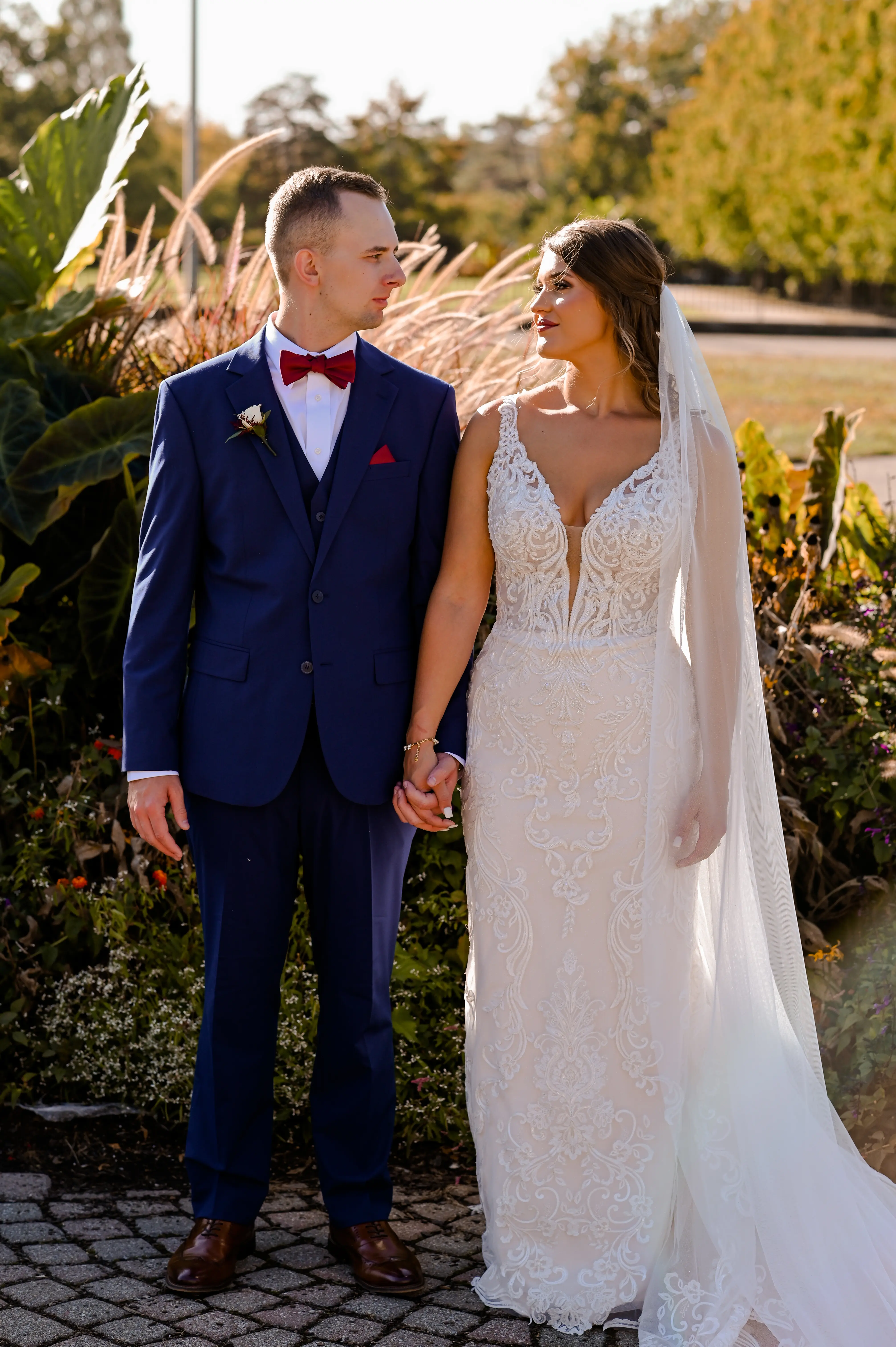 Bride wearing Hamilton wedding dress by Sottero and Midgley holding hands with her husband