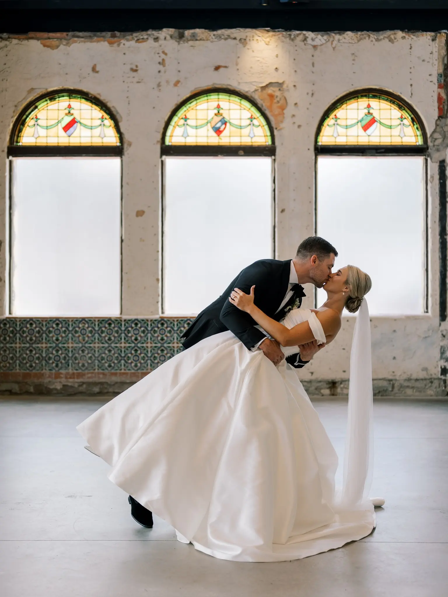 Bride wearing Zinaida by Maggie Sottero kissing her husband