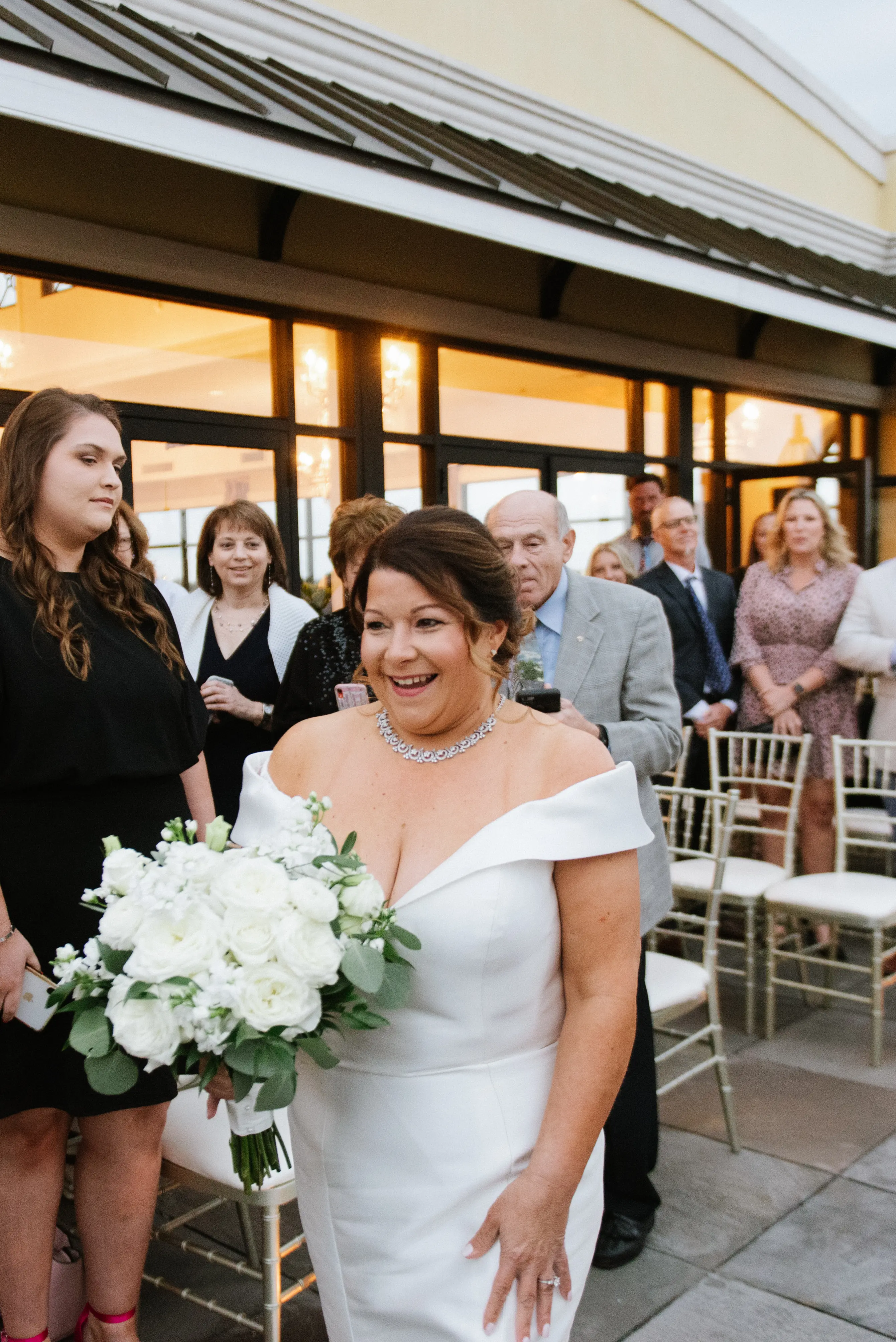 Bride wearing elegant off the shoulder wedding dress
