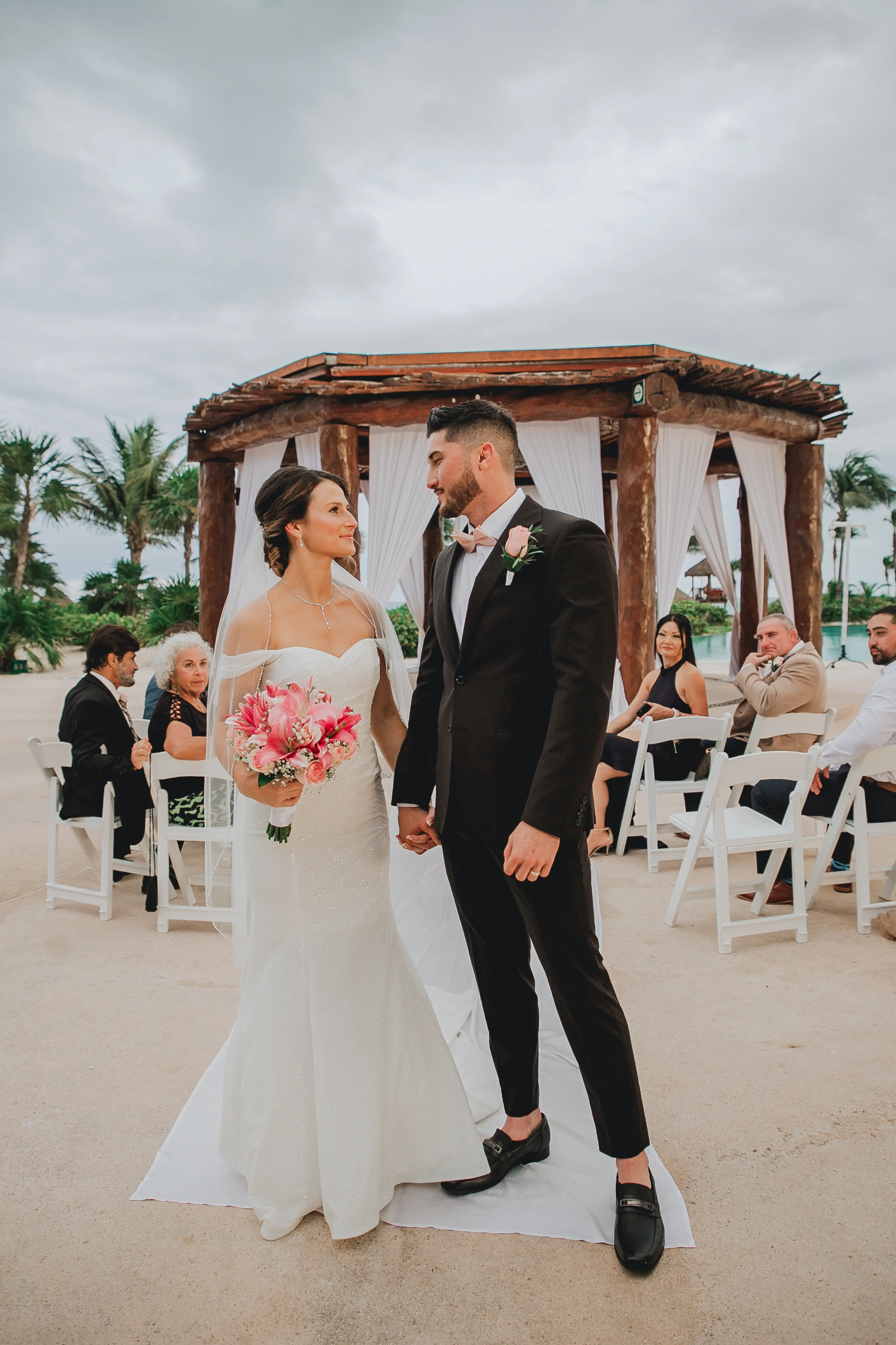 Bride Wearing Sparkly Fit And Flare Wedding Dress Called Anniston Lane By Maggie Sottero Looking At Groom