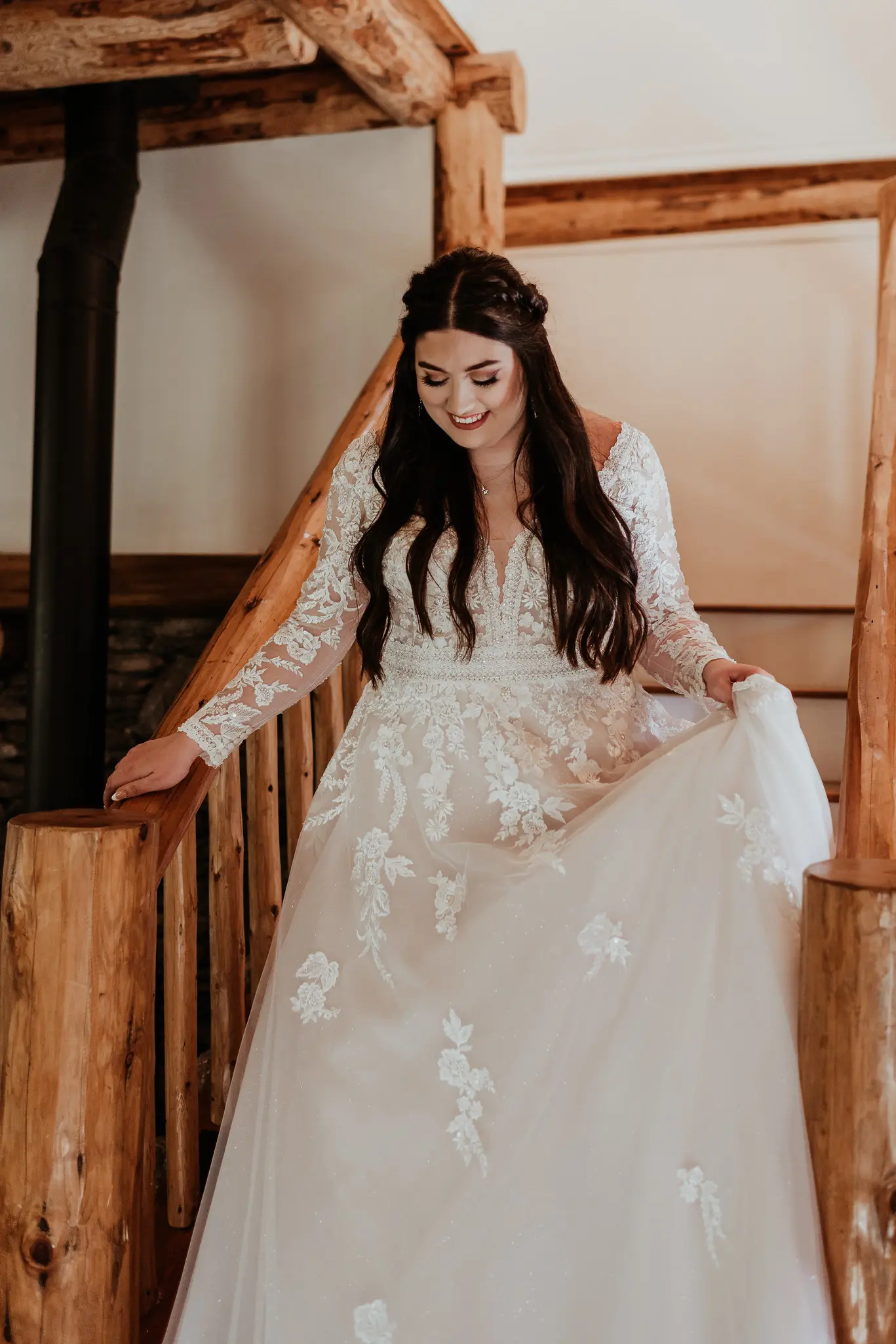 Bride Wearing Long Sleeve Lace Wedding Dress Called Raphael By Maggie Sottero Walking Down Rustic Wooden Stairs