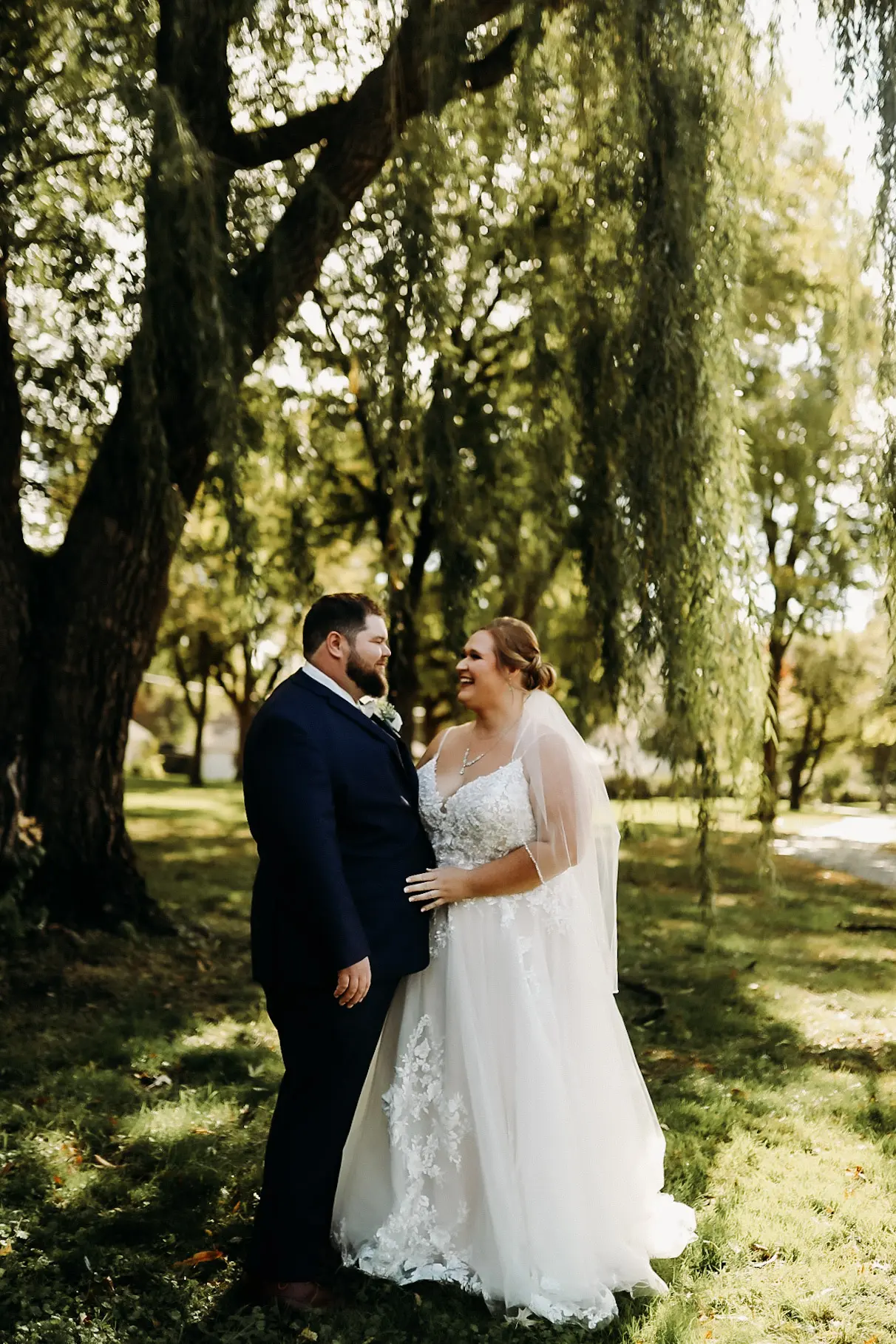 Bride wearing Pia wedding dress by Maggie Sottero laughs with her husband