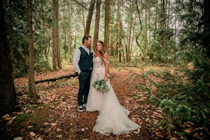 Bride wearing Boho Wedding Dress called Stevie by Maggie Sottero in the forest with her groom