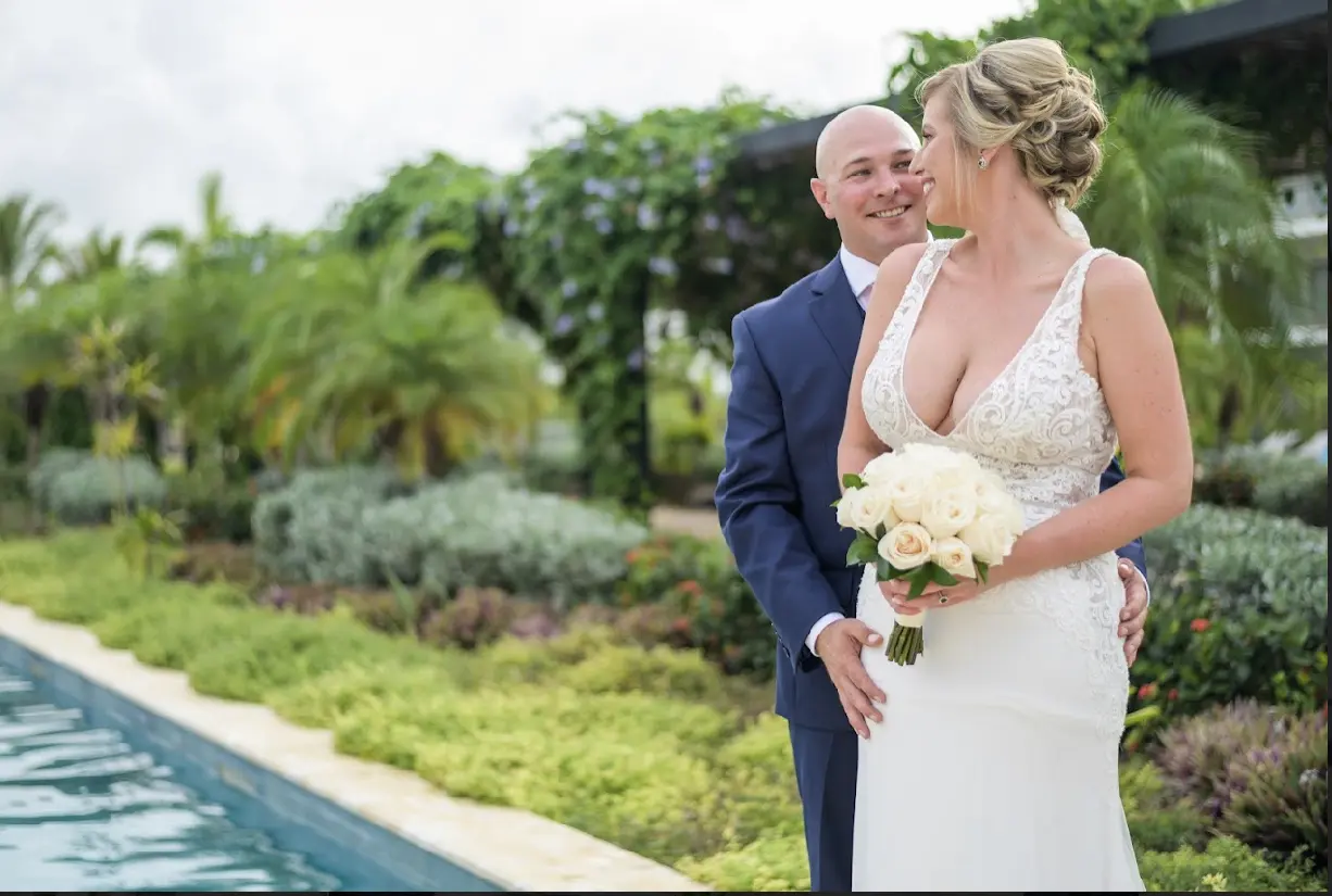 Bride and groom laughing together looking into each others eyes.
