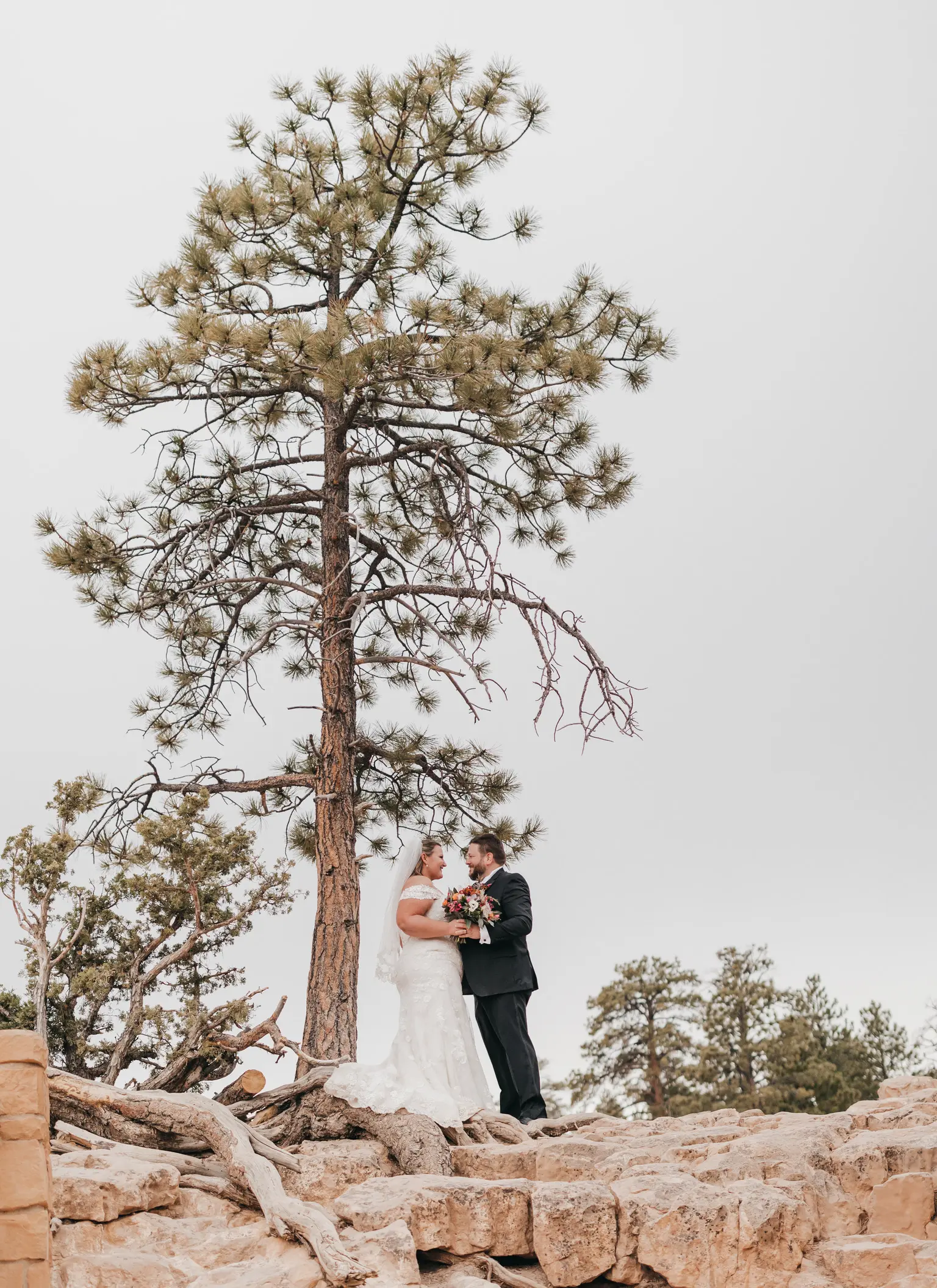 bride with groom in corset back fit and flare wedding dress