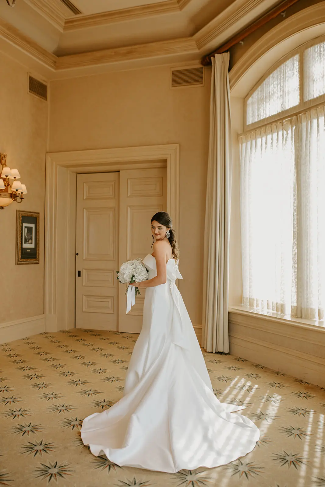 Bride Wearing Strapless Wedding Dress Featuring Big Bow Mitchell By Maggie Sottero
