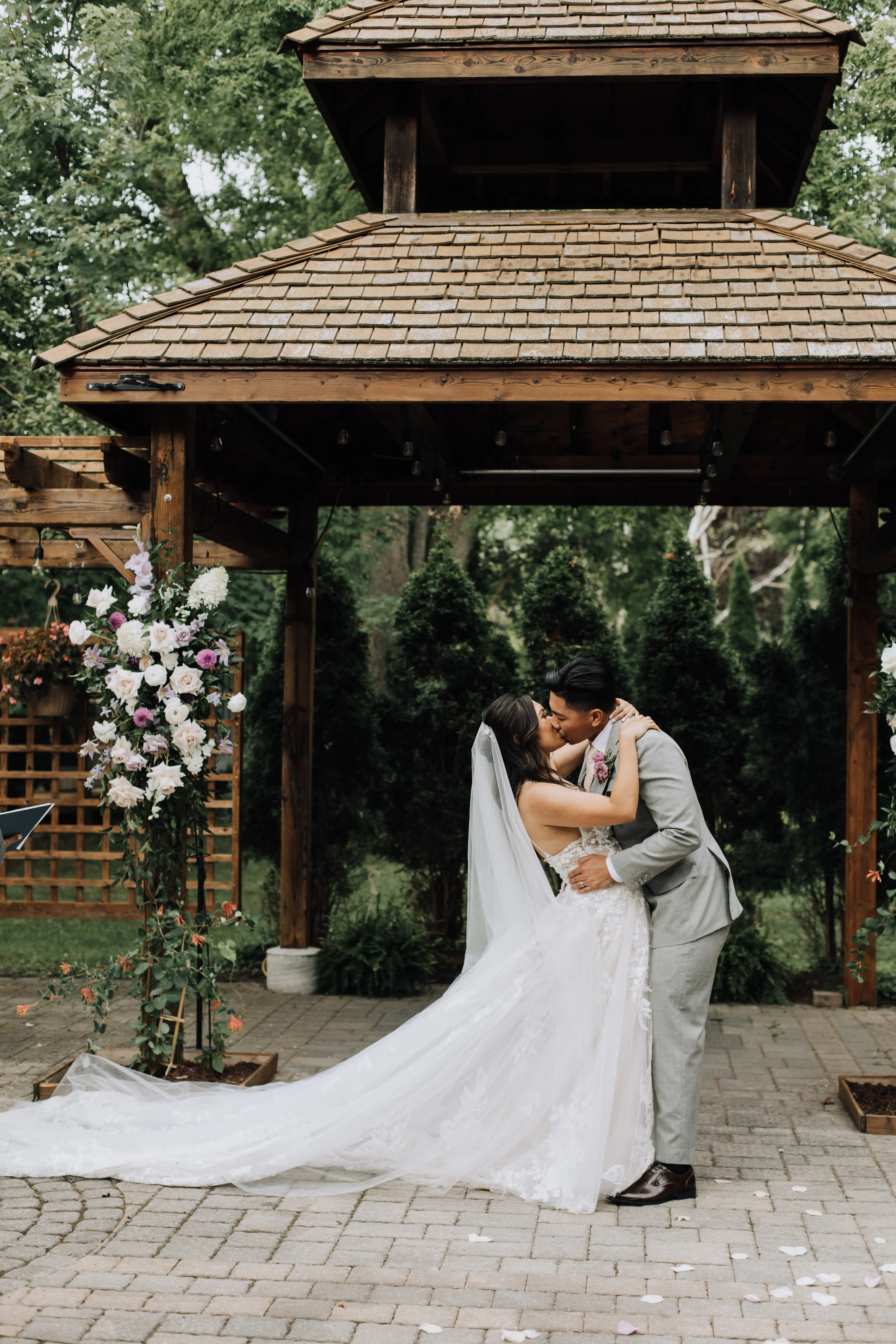 Bride Wearing A-Line Romantic Wedding Dress Called Marlow By Sottero And Midgley Kissing Groom Under Gazebo
