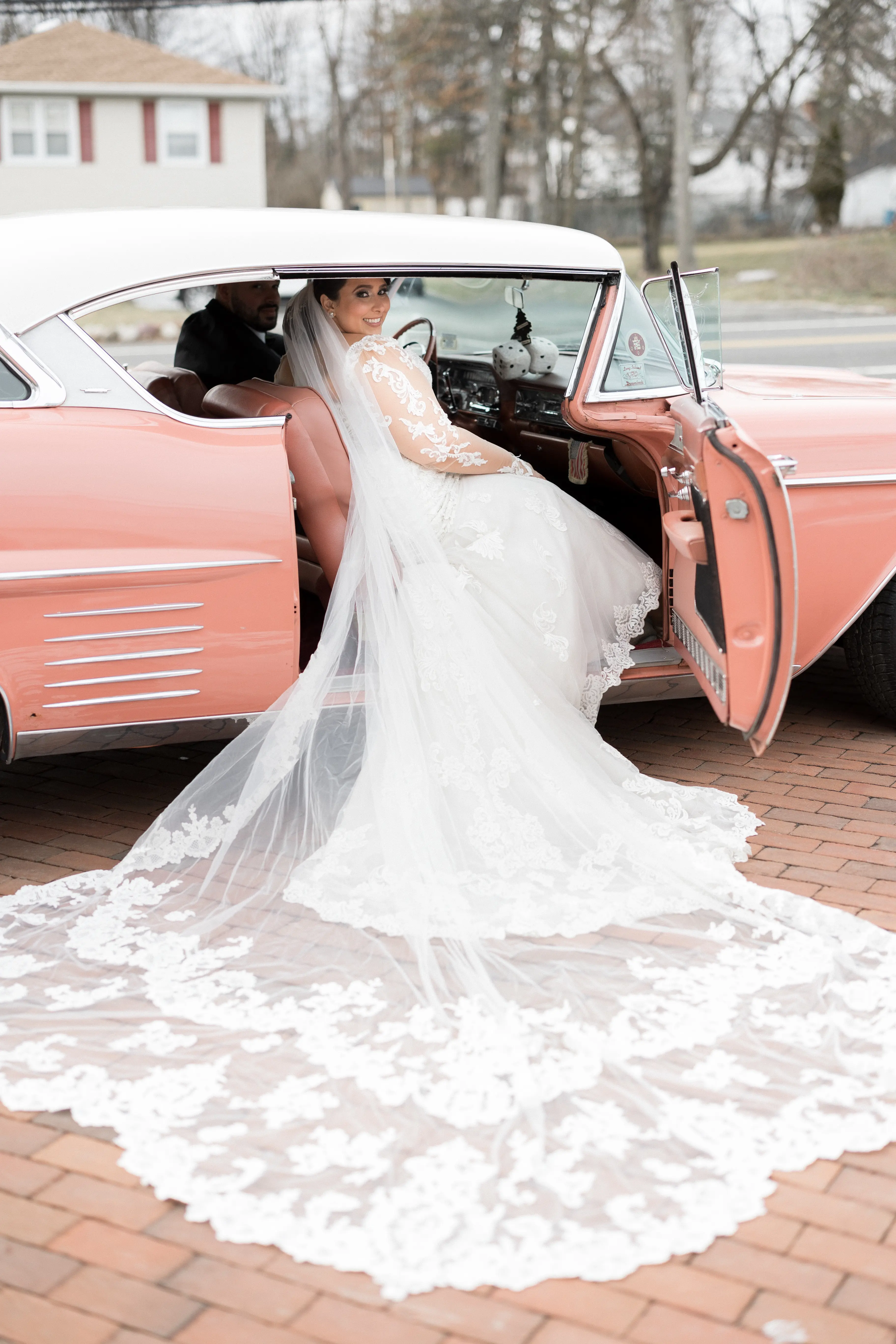 Bride Wearing Sexy Lace Long Sleeve Wedding Dress Called Fiona By Maggie Sottero Sitting In Vintage Car