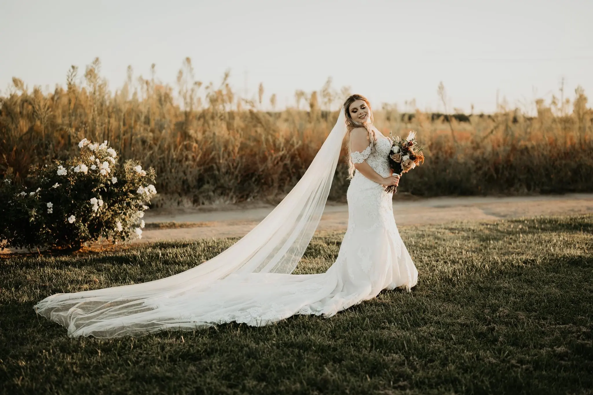 Bride In Lacey Off The Shoulder Wedding Dress Named Fiona By Maggie Sottero With Long Veil