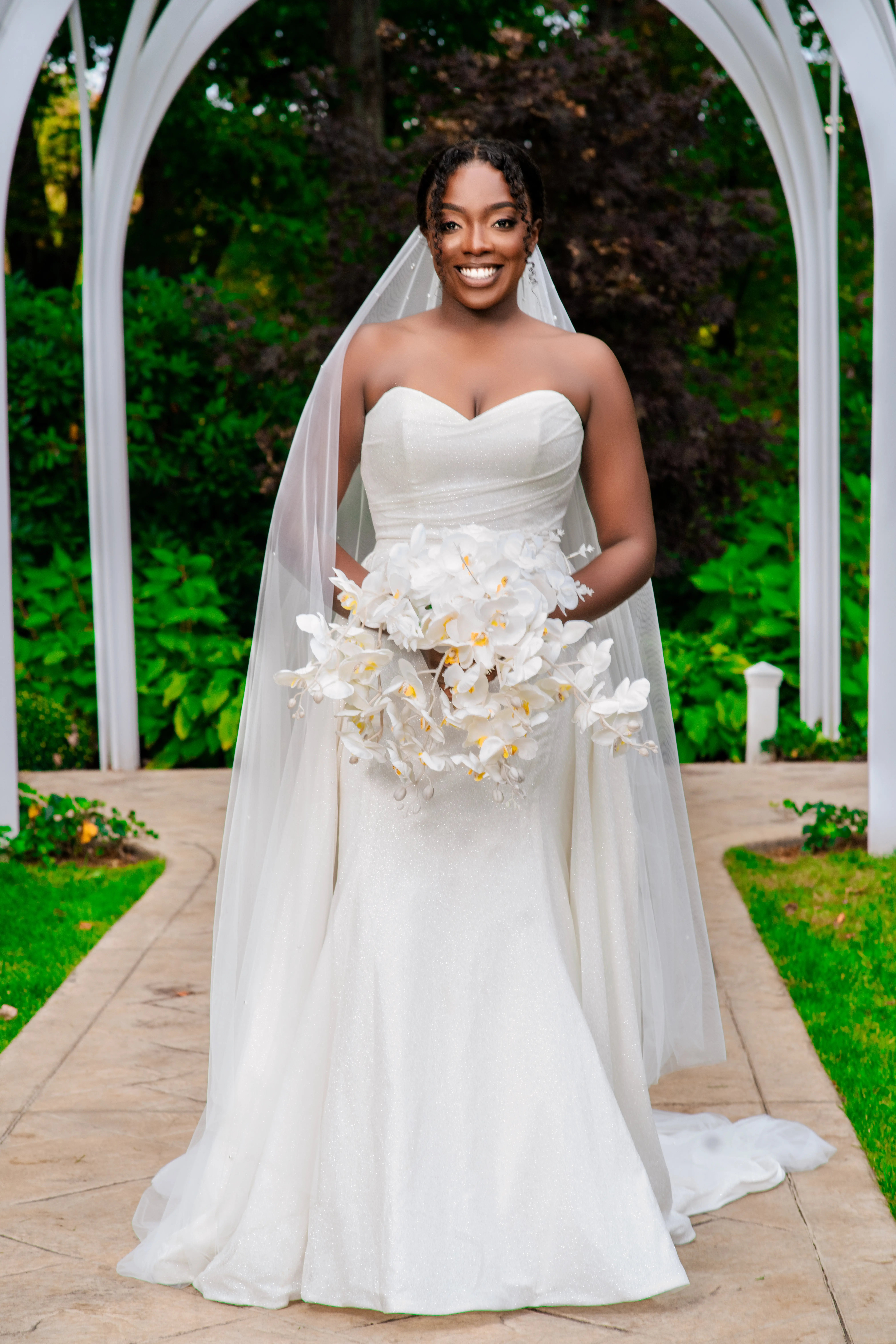 Bride Wearing Simple Fit and Flare Wedding Dress Called Anniston Lane With A White Bouquet