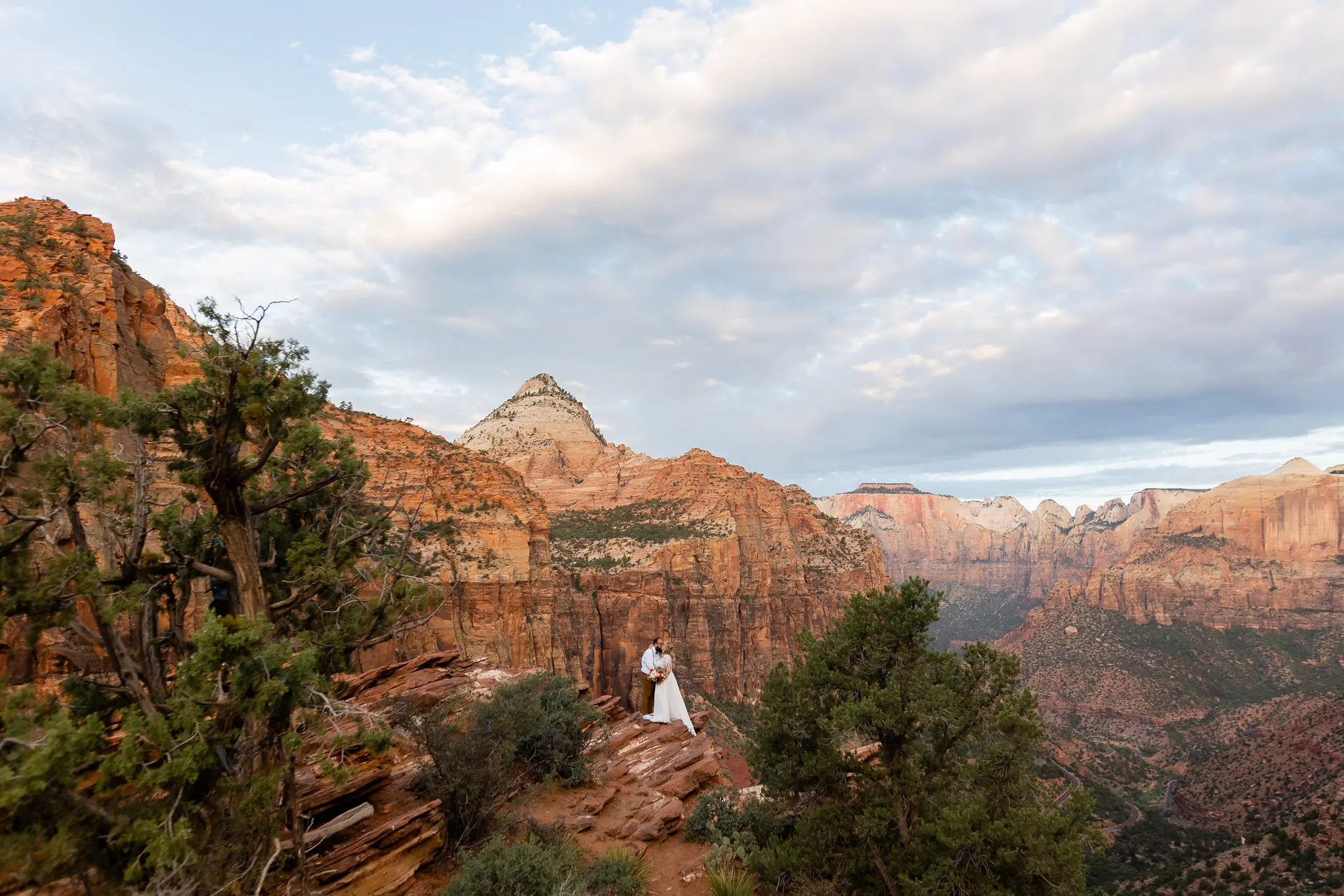 Real Bride in Long Sleeved, Thigh-High Slit Wedding Dress Named Lorraine by Rebecca Ingram with Groom