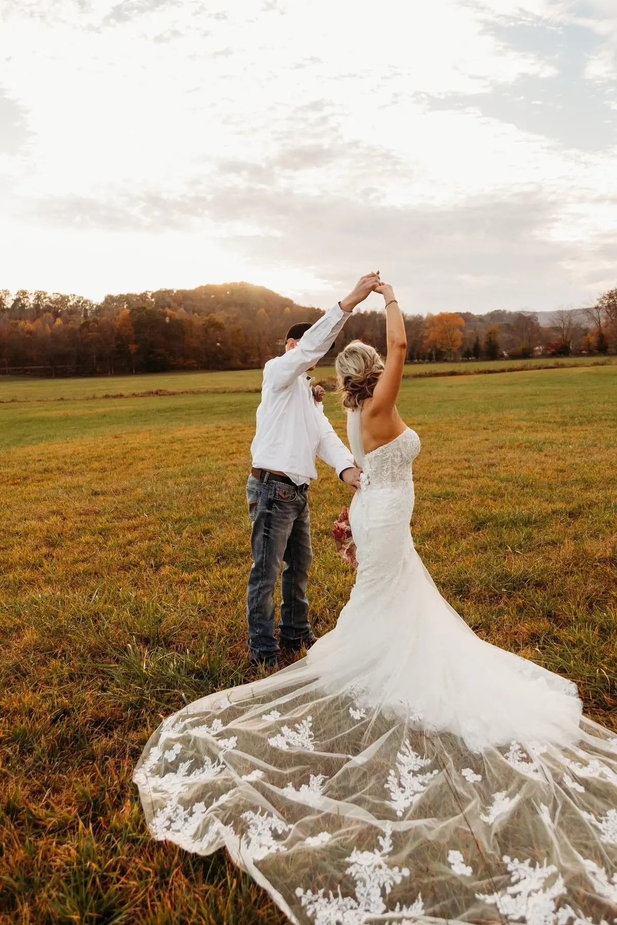 Bride wearing Lennon wedding dress by Maggie Sottero being spun by her husband