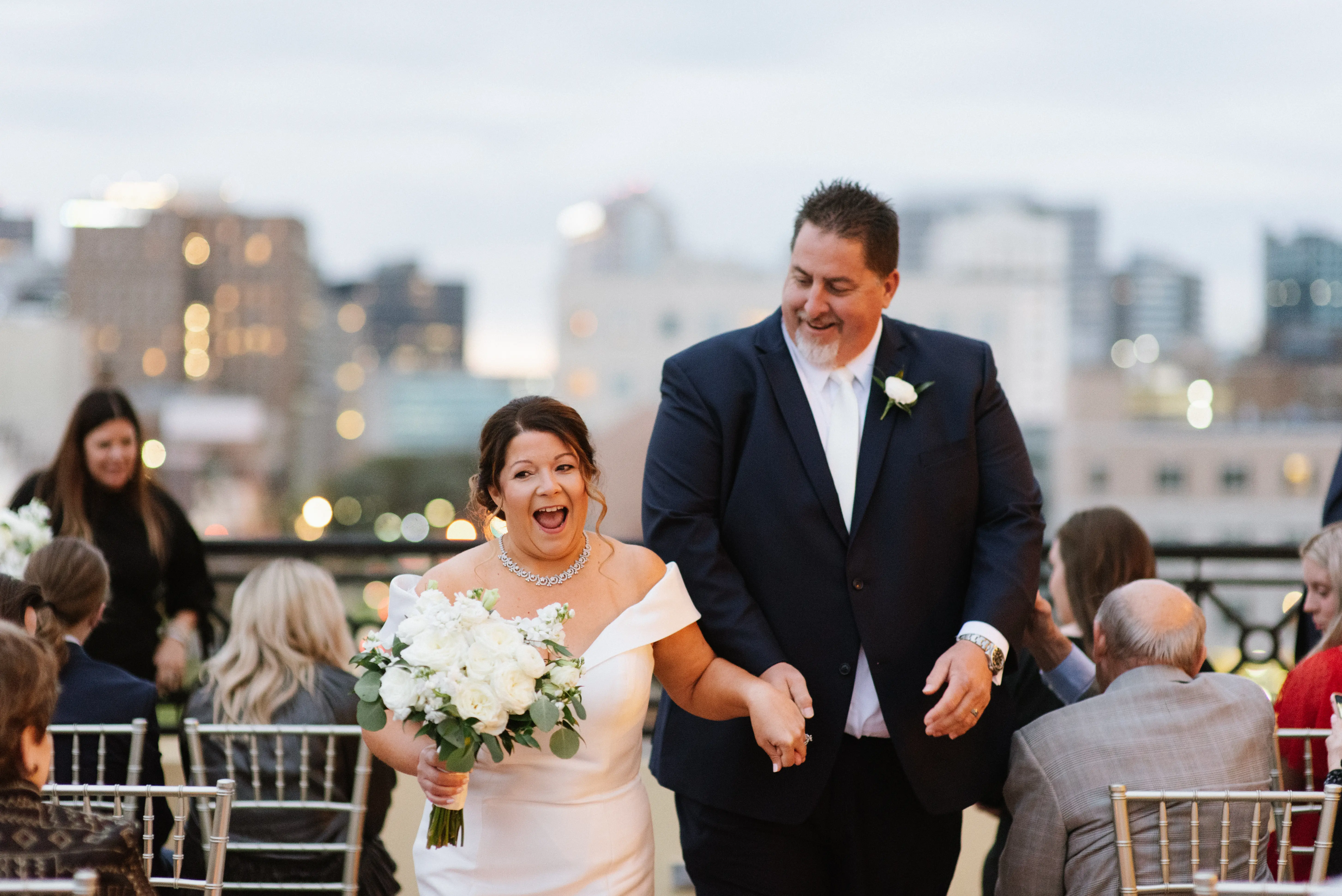 Bride with groom wearing elegant off the shoulder wedding dress