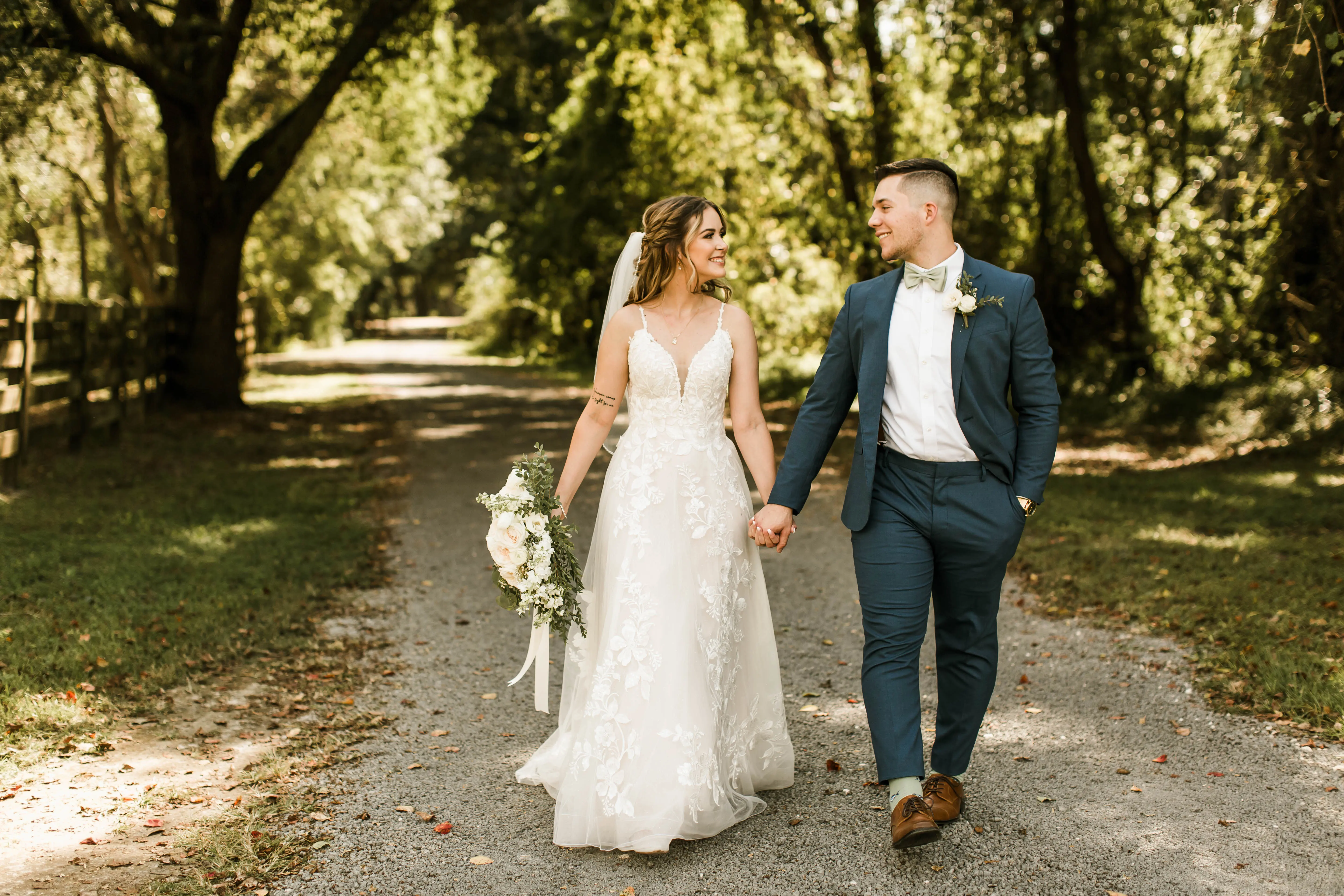 Bride with groom wearing affordable floral ballgown wedding dress.