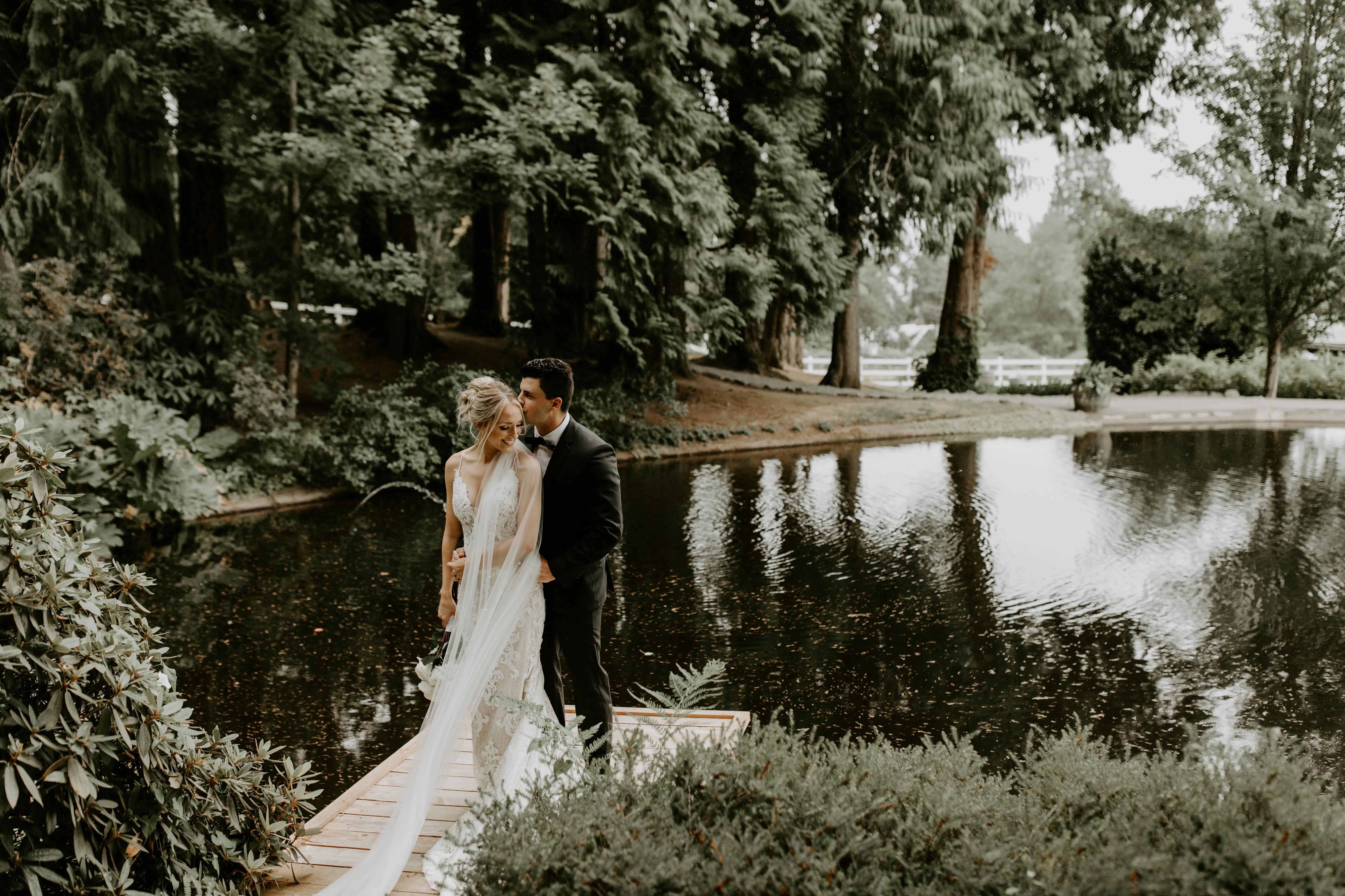 Bride with groom wearing romantic lace sheath wedding dress
