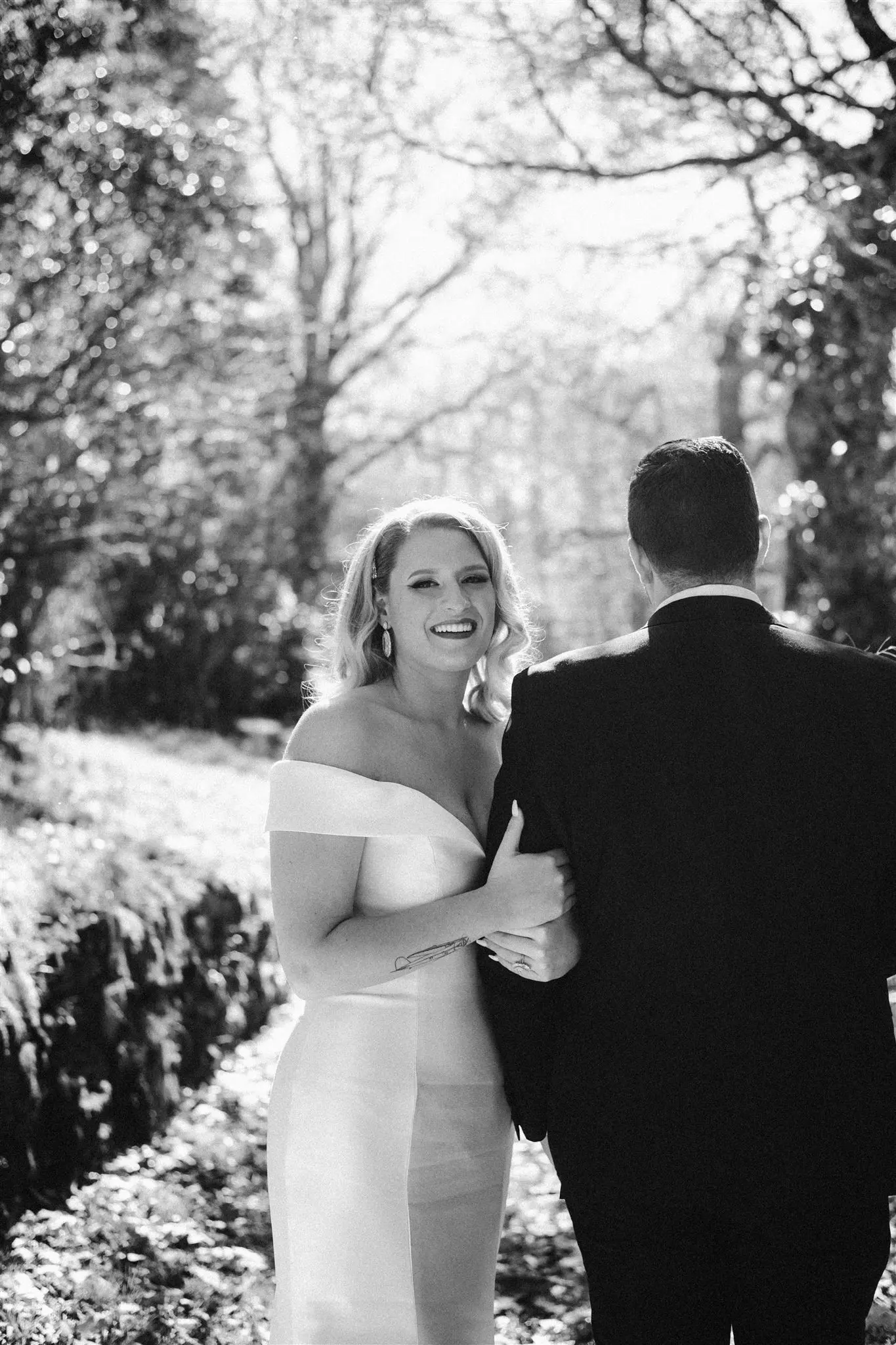 Groom With Bride Wearing Vintage Glamour Off-The-Shoulder Wedding Dress Josie By Rebecca Ingram