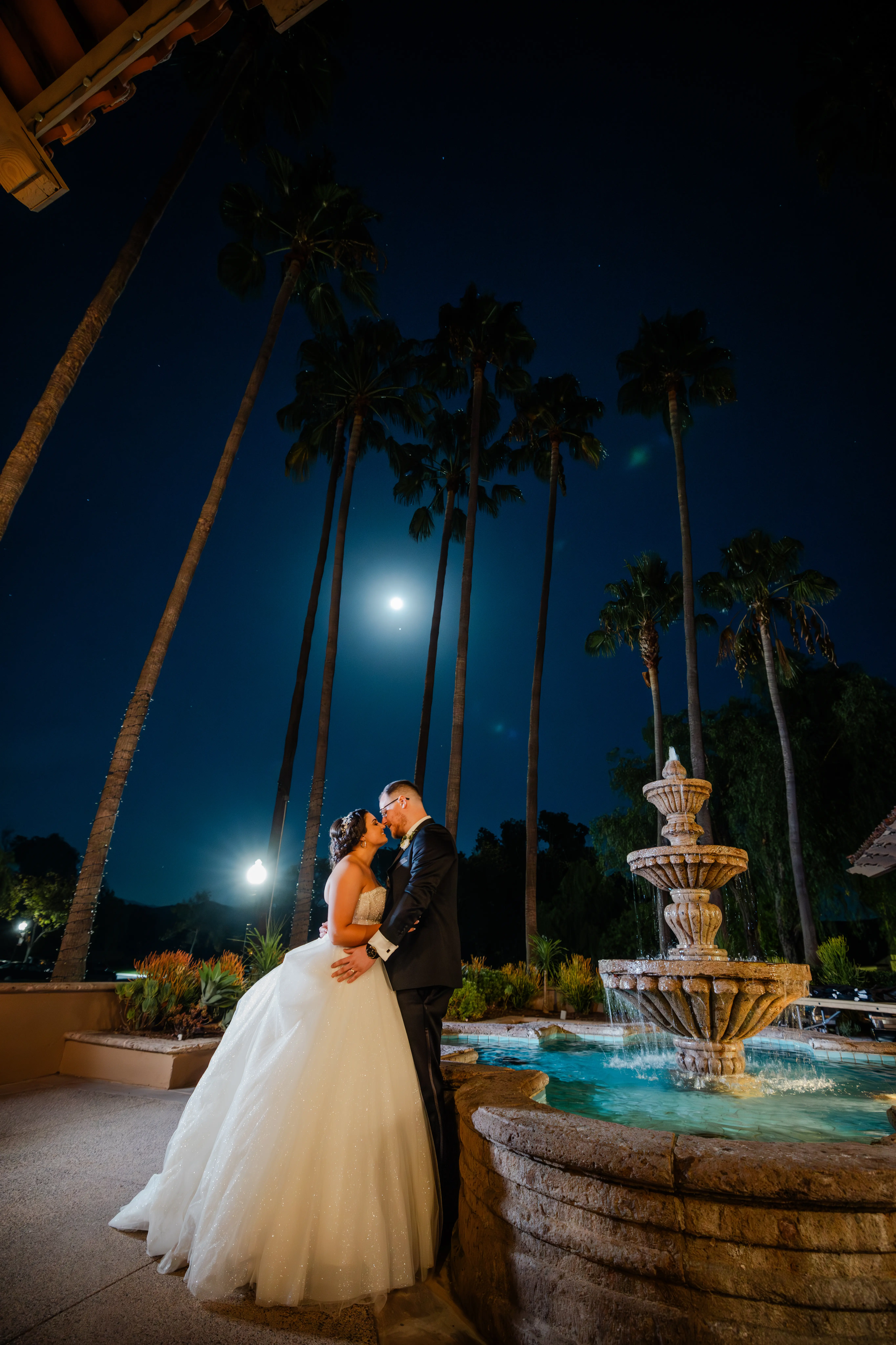 Bride Wearing Sparkly Princess Wedding Dress Called Elton By Sottero And Midgley With Groom Next To A Fountain