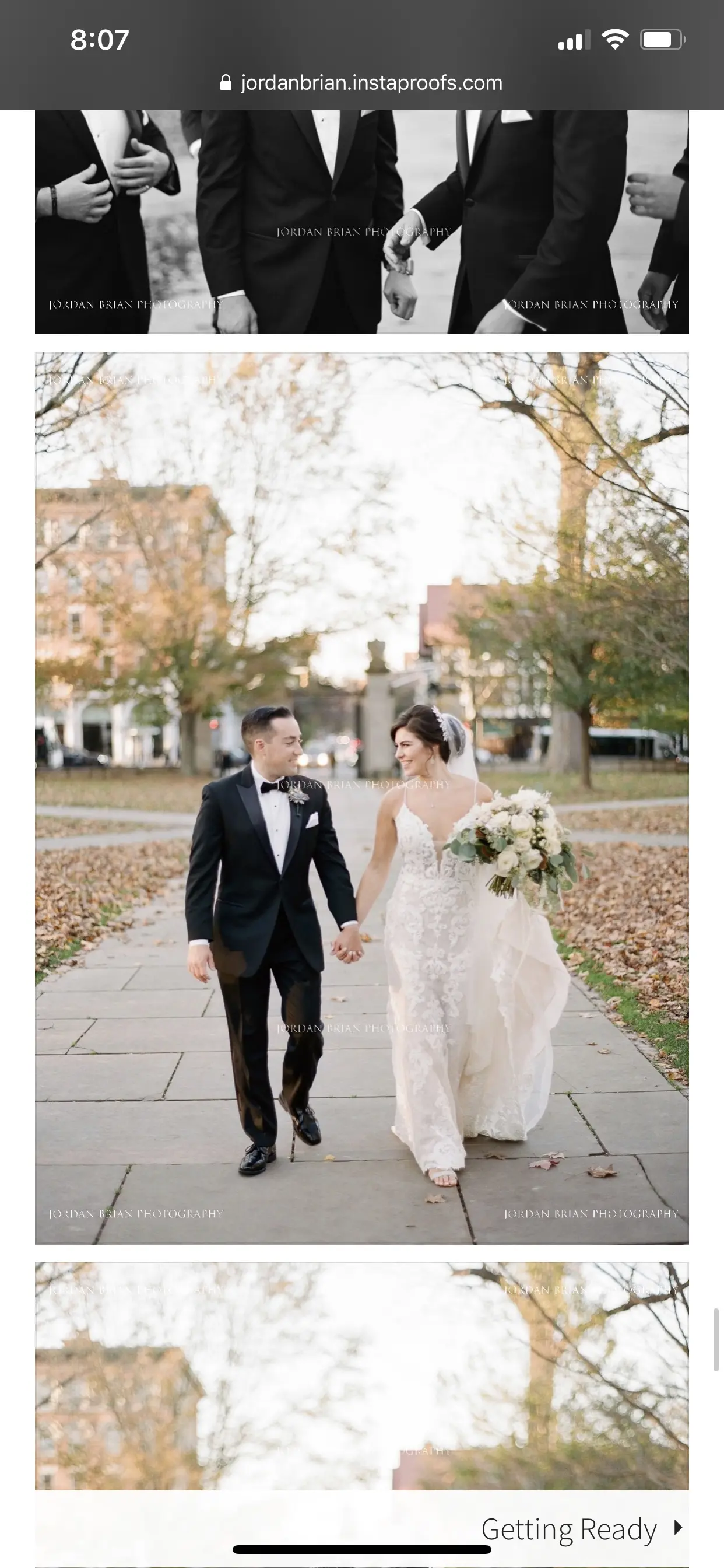 Newlyweds smiling at each other hand in hand bride wearing dress called Tuscany Lynette.