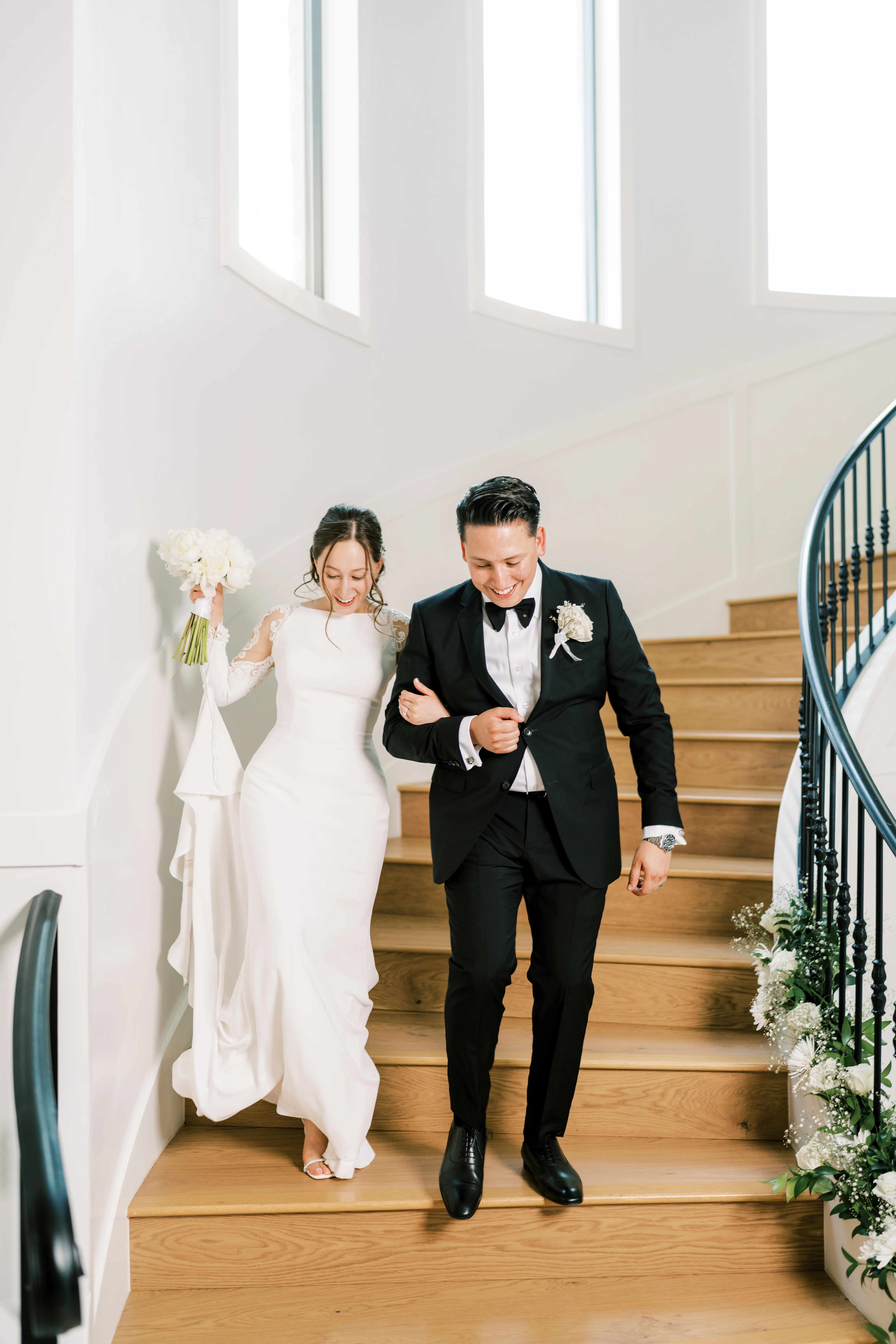 Bride Wearing Simple Long Sleeve Wedding Dress Called Bethany By Rebecca Ingram Smiling With Groom