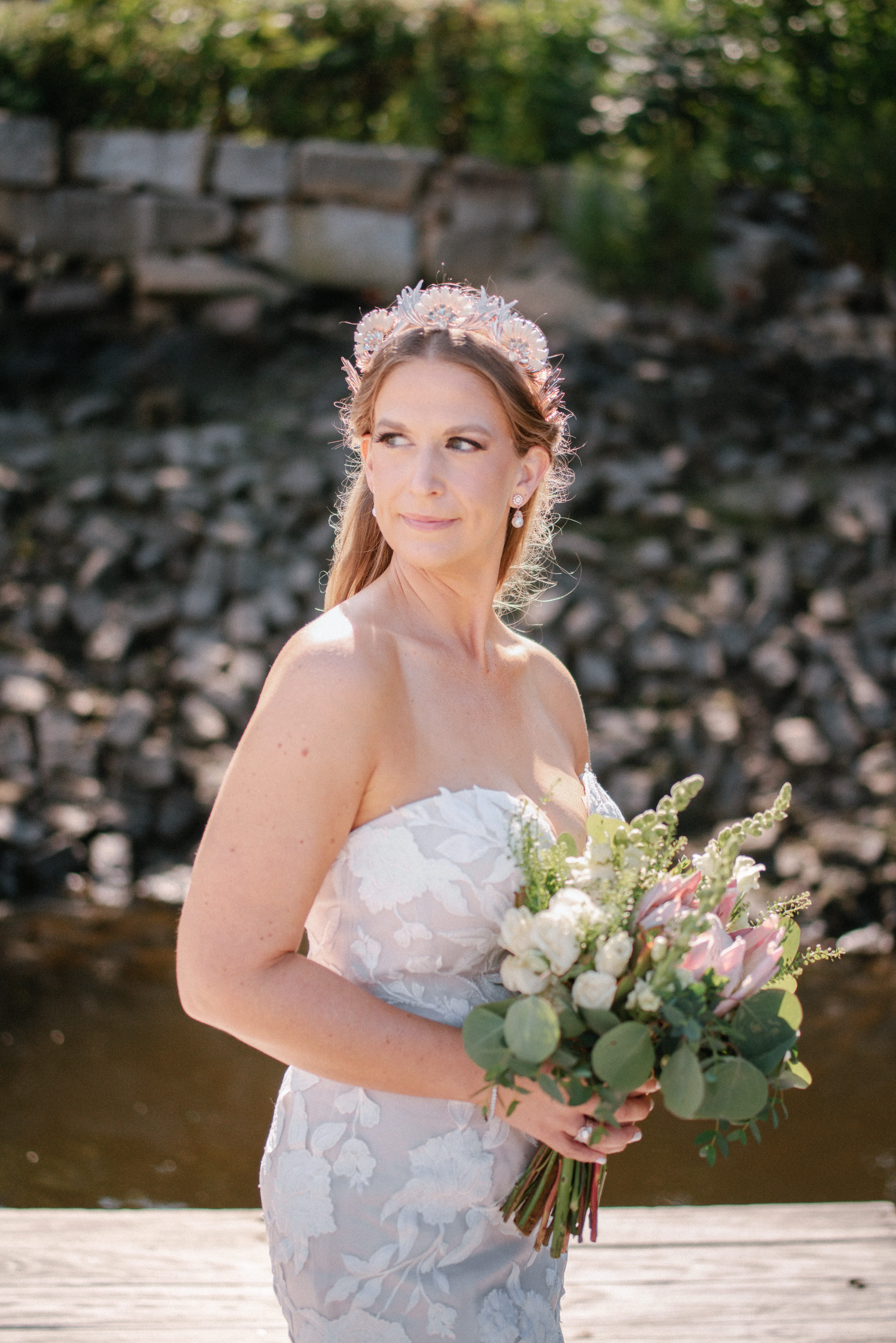 Bride wearing strapless mermaid wedding dress with plunging V-neck.